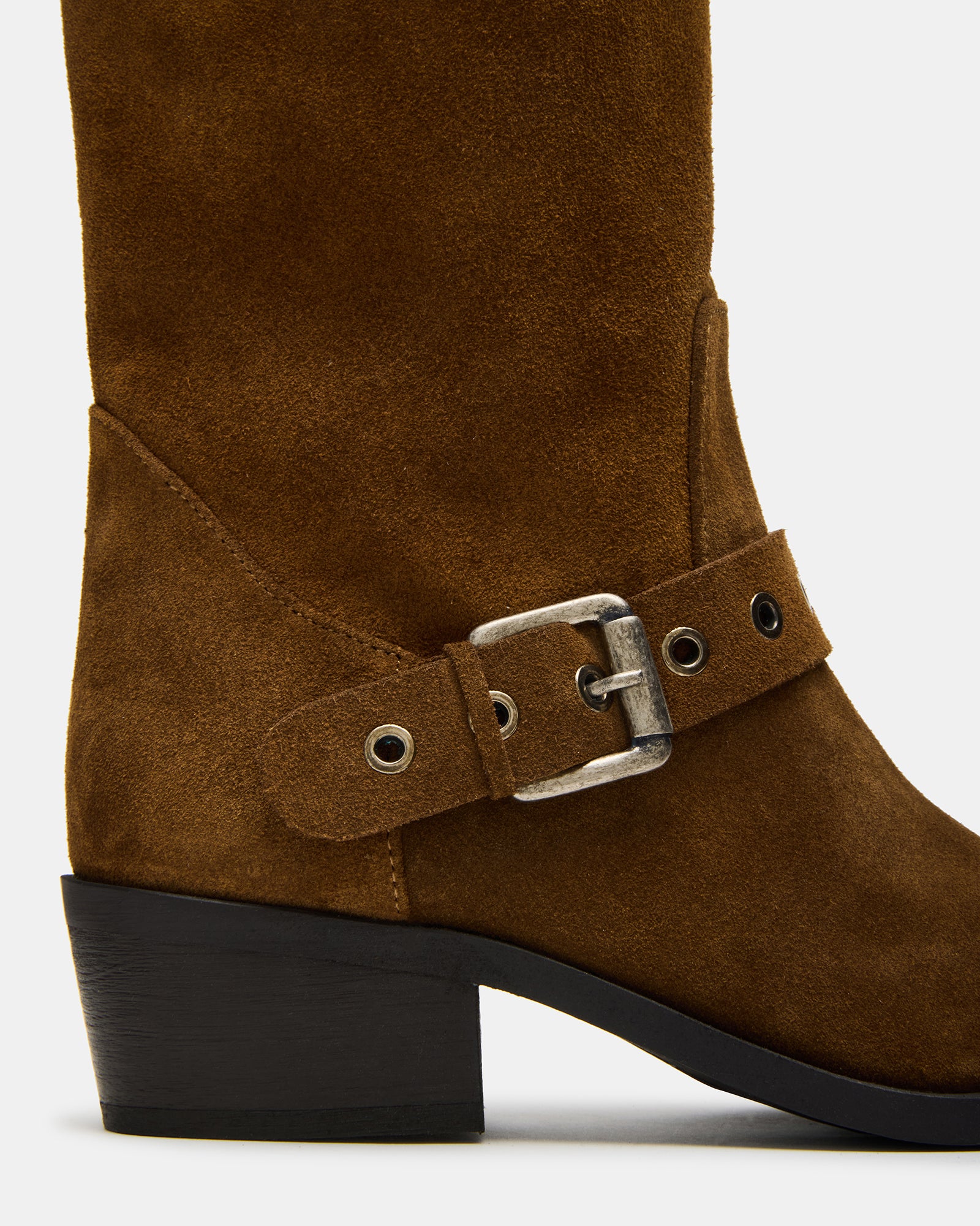 Side view of brown suede ankle boots on foot