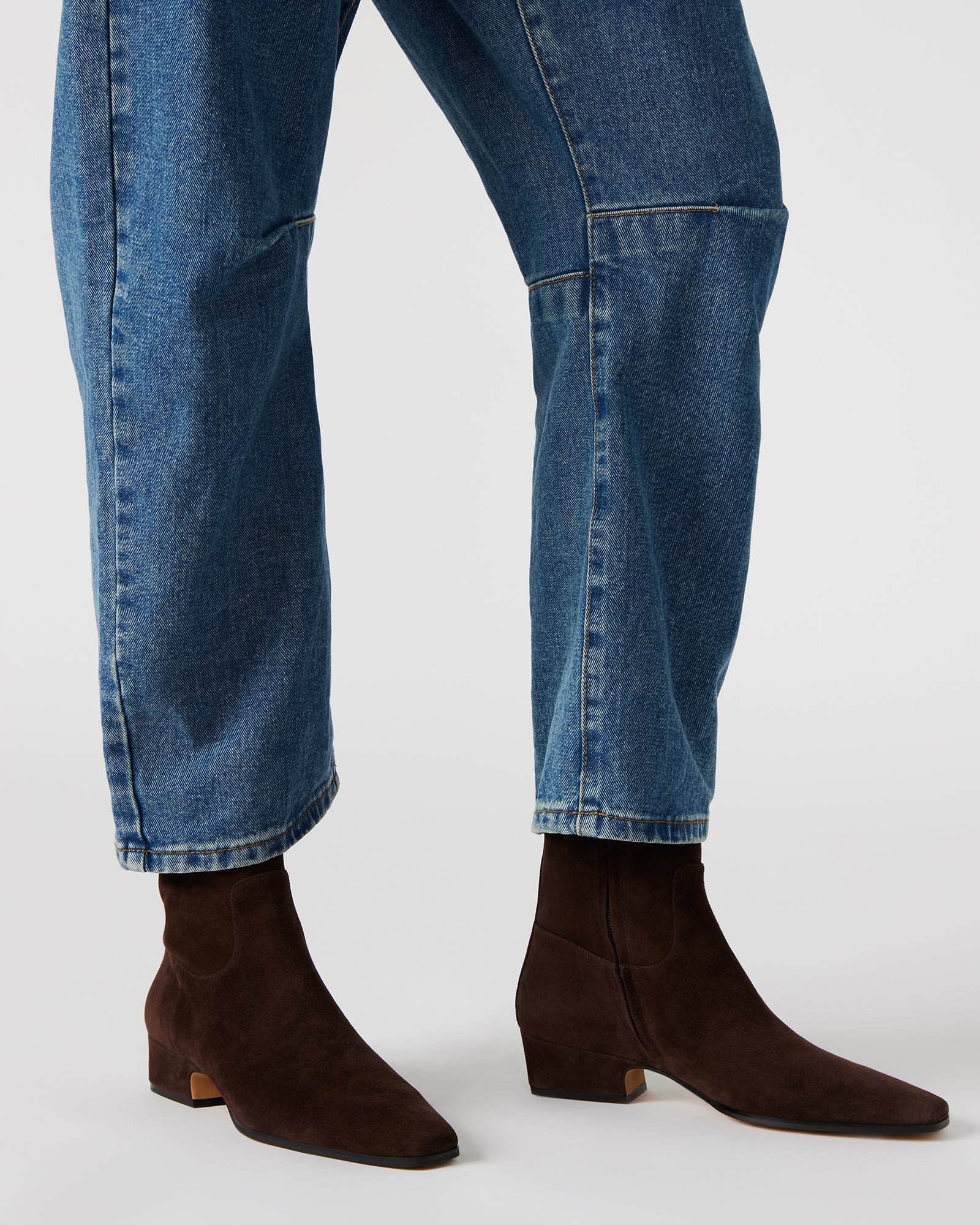 Close-up of the suede material on dusty chocolate ankle boots.