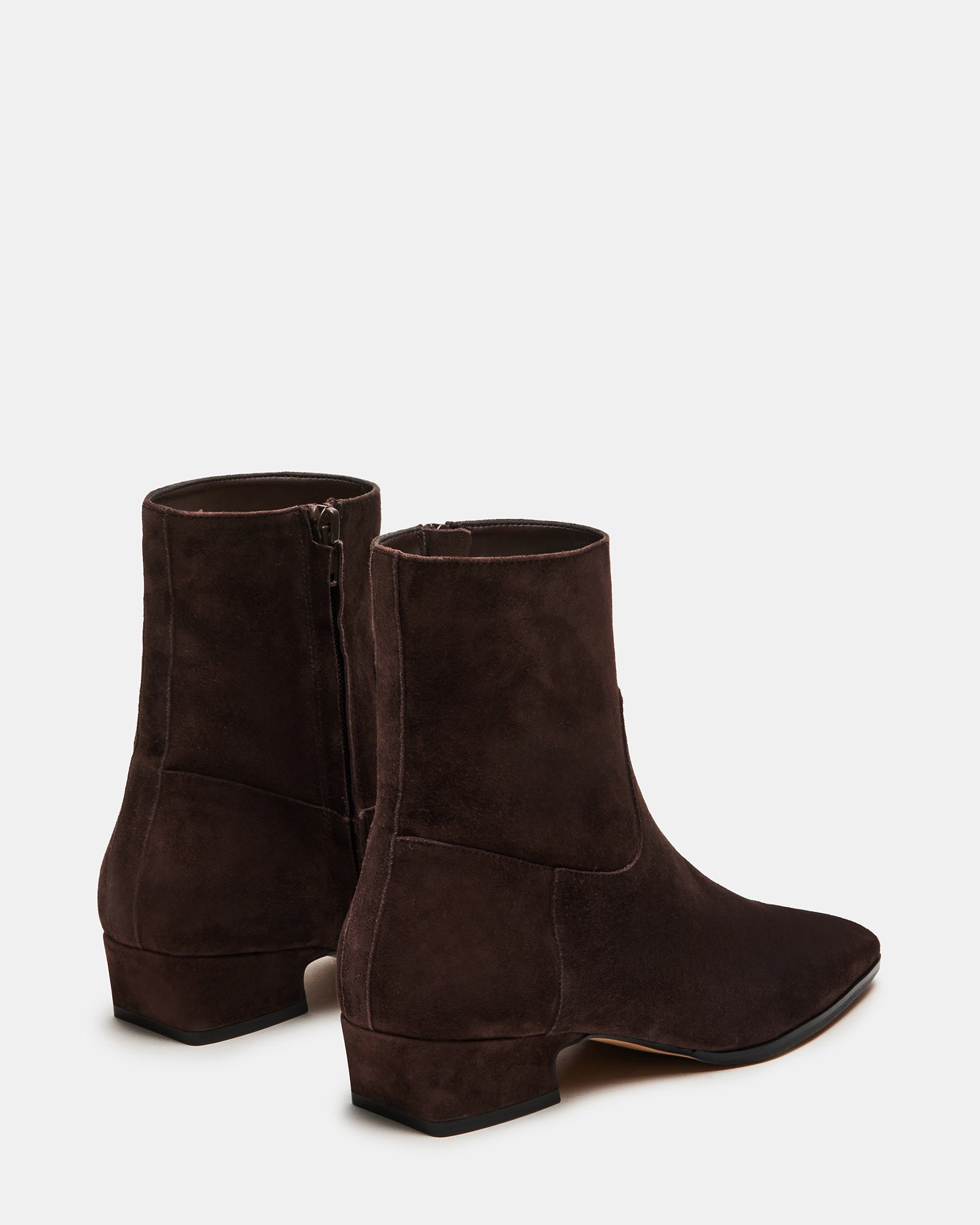 Model wearing brown suede ankle boots styled with casual outfit.