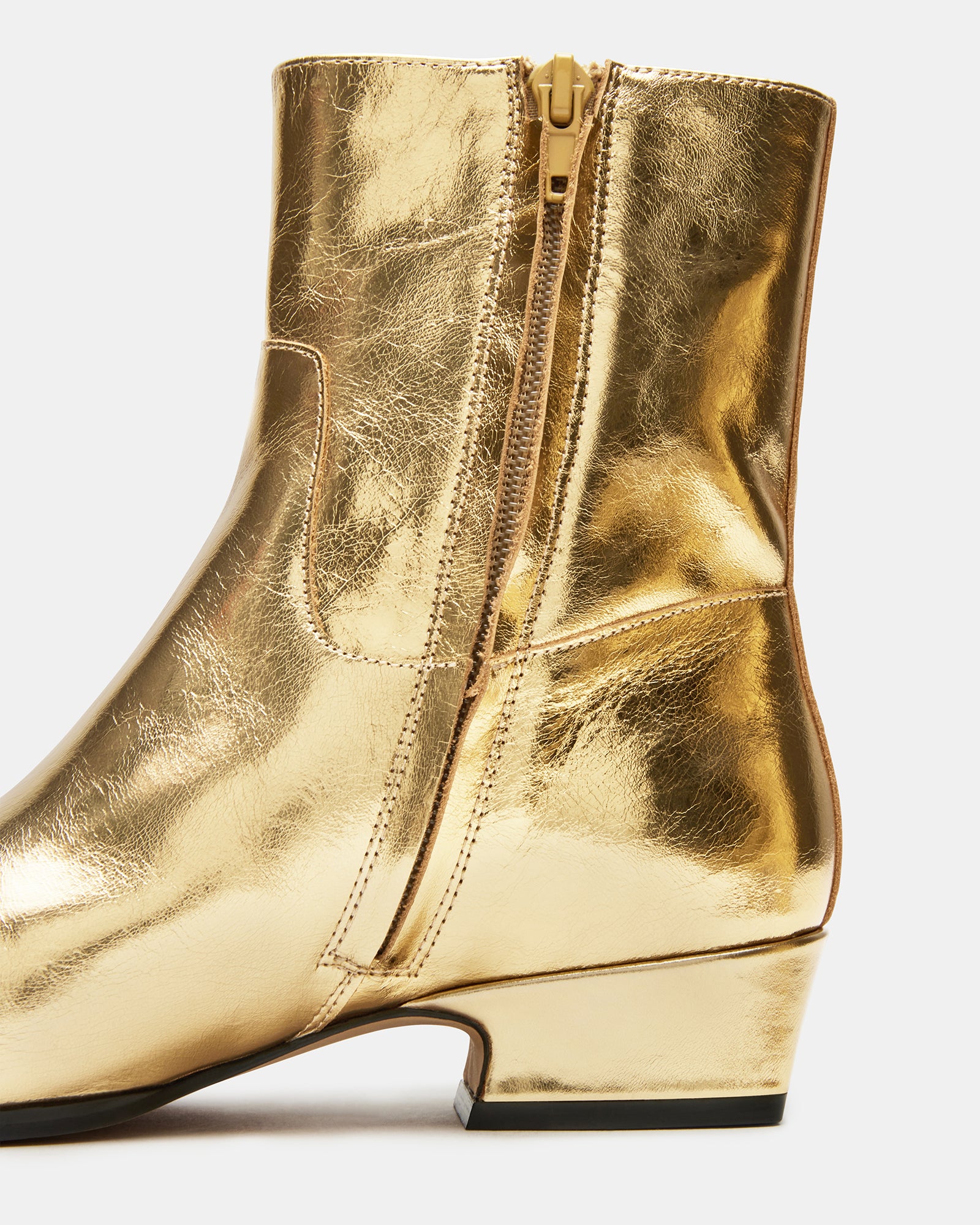 Dusty Gold leather ankle boots with square toe on a city street