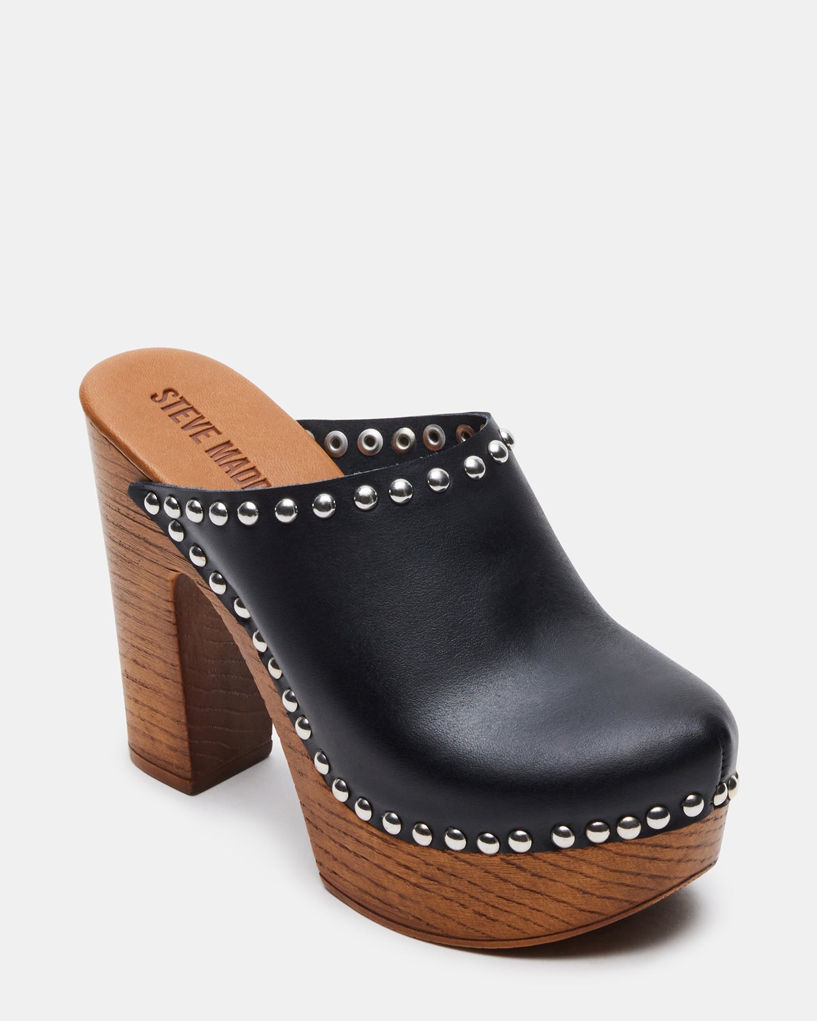Close-up of heeled mules platform, showing patent leather shine and wooden base