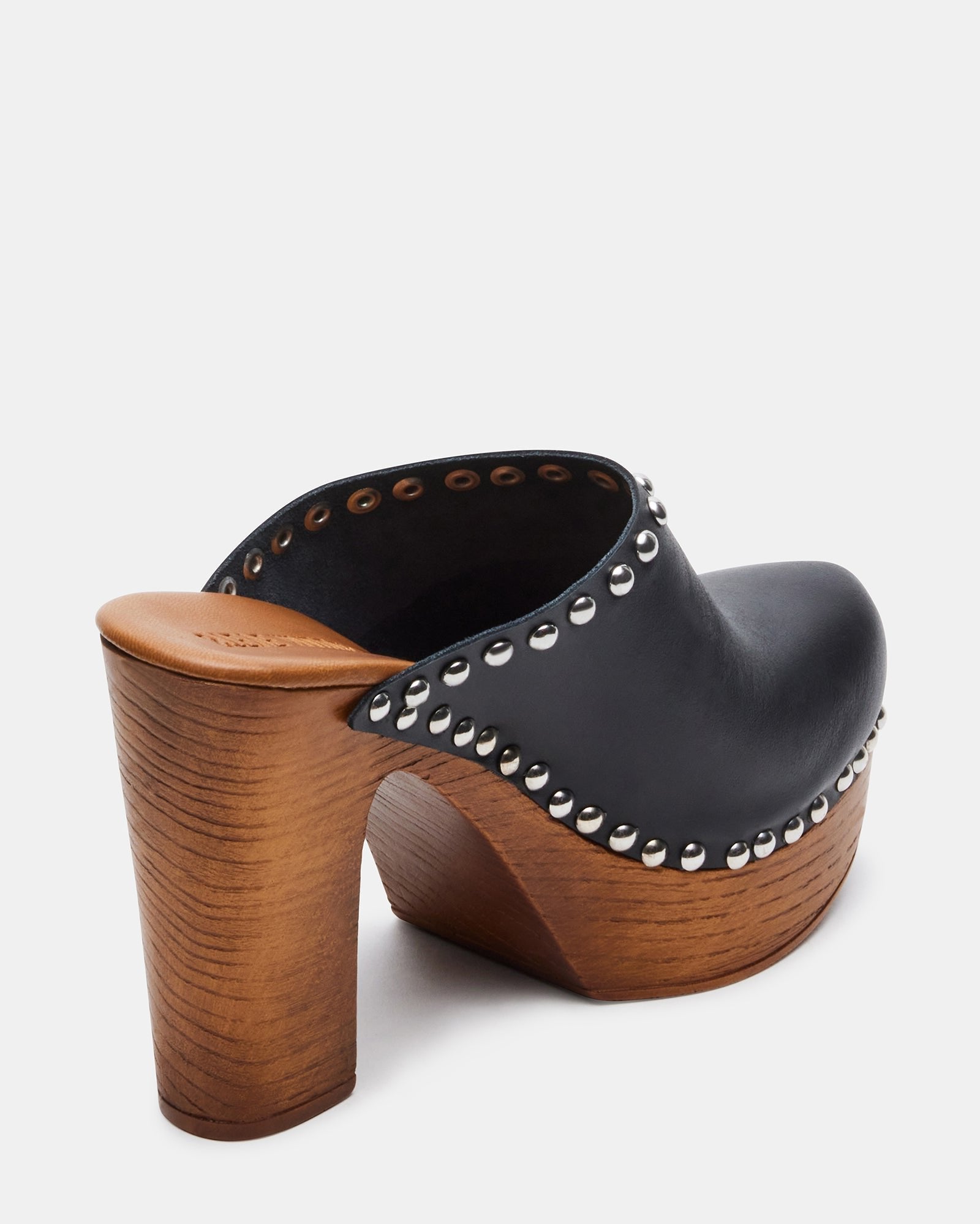 Close-up of heeled mules platform, showing patent leather shine and wooden base
