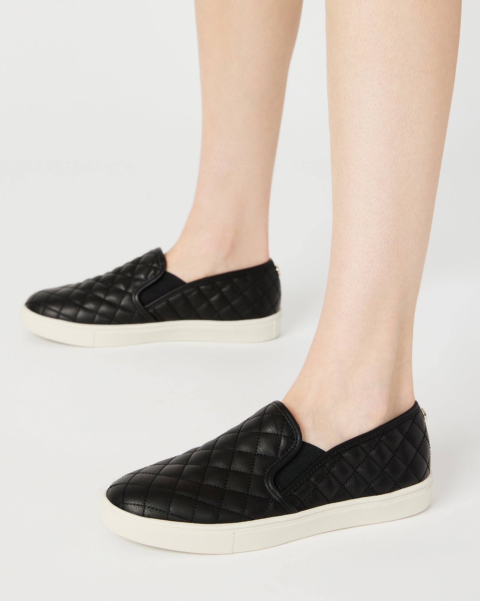 Close-up of vegan leather texture on slip-on sneakers.