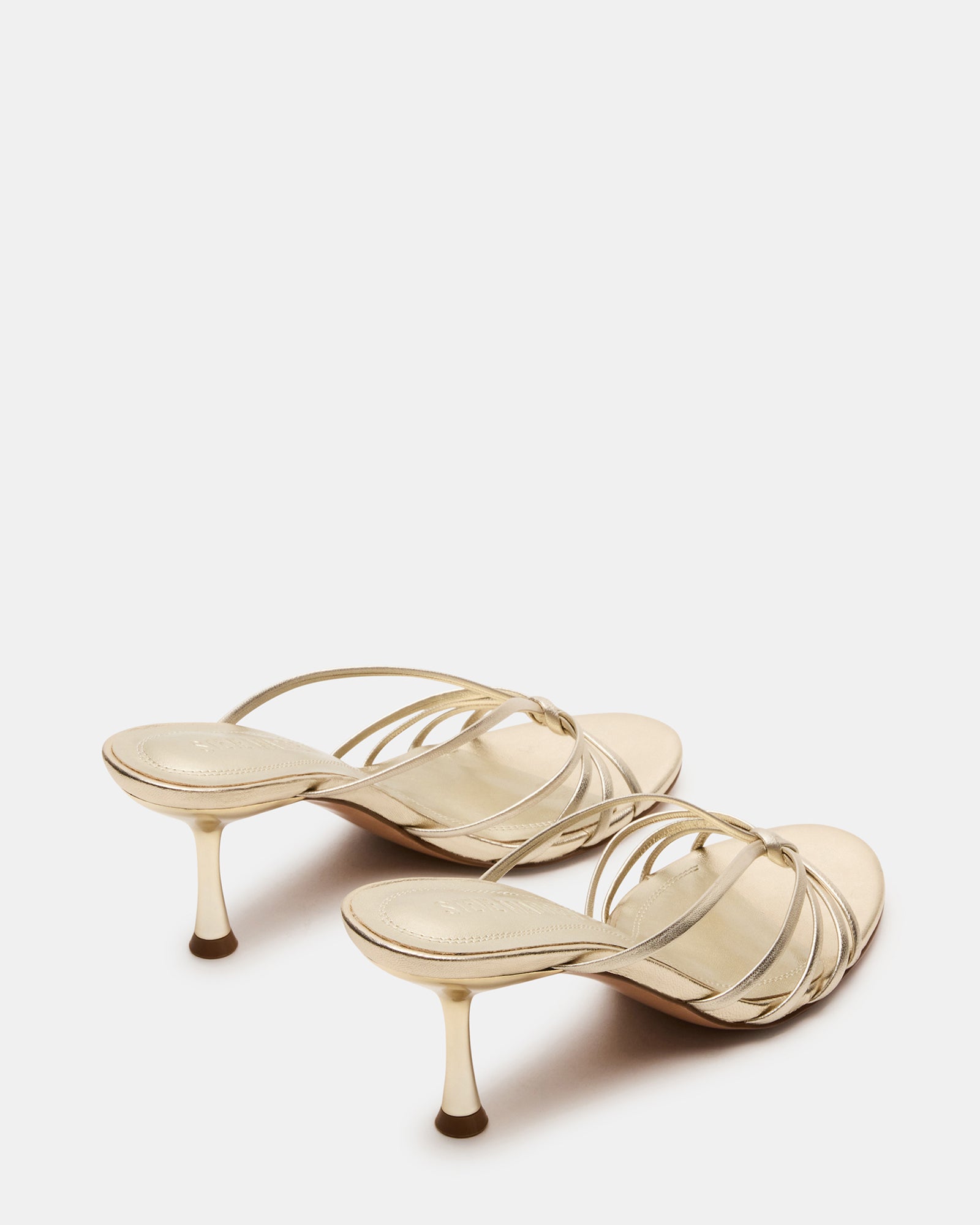 Fashionable scene of the champagne leather heels paired with a chic outfit for a night out