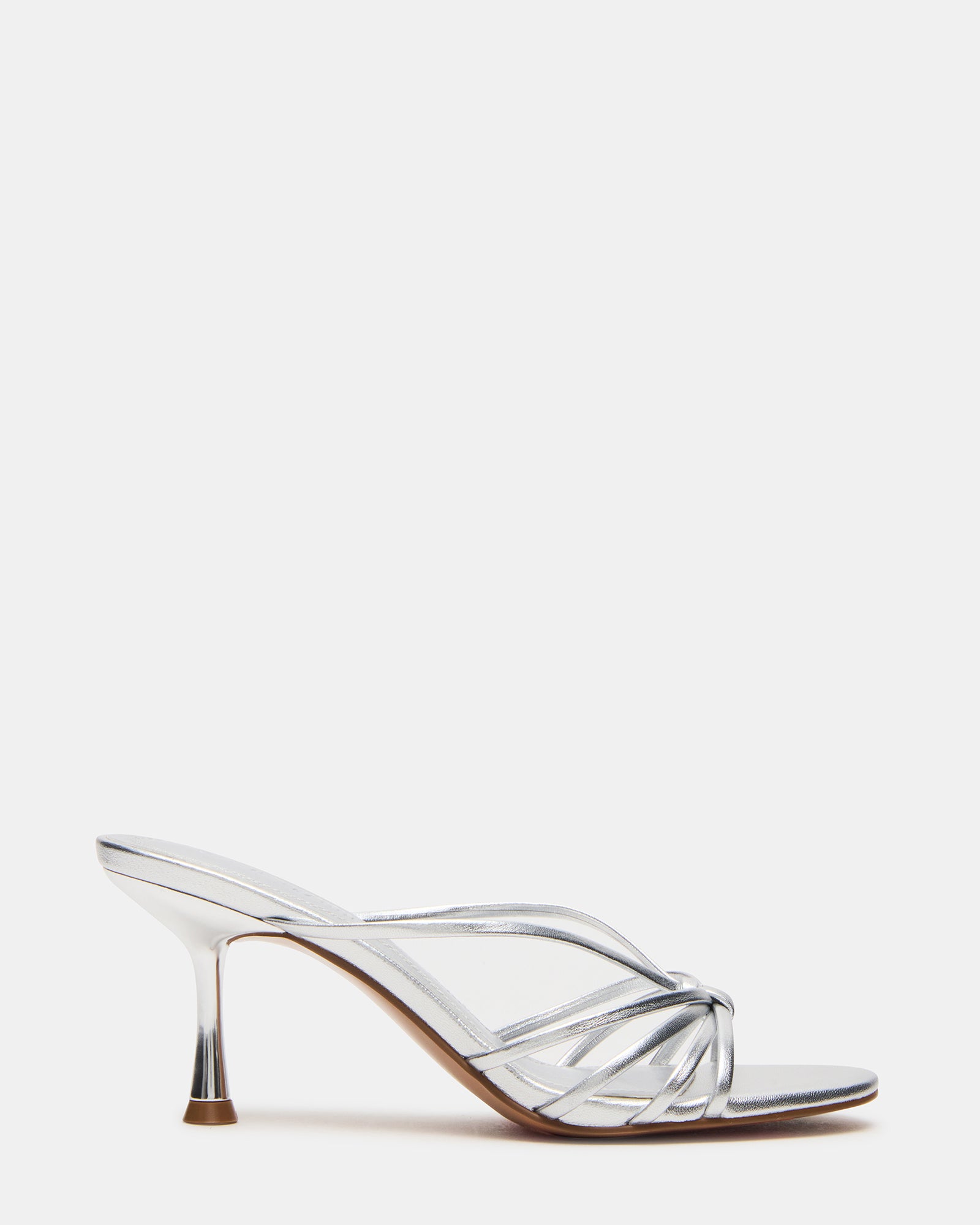 EDNA silver kitten heel mules on marble background with soft lighting