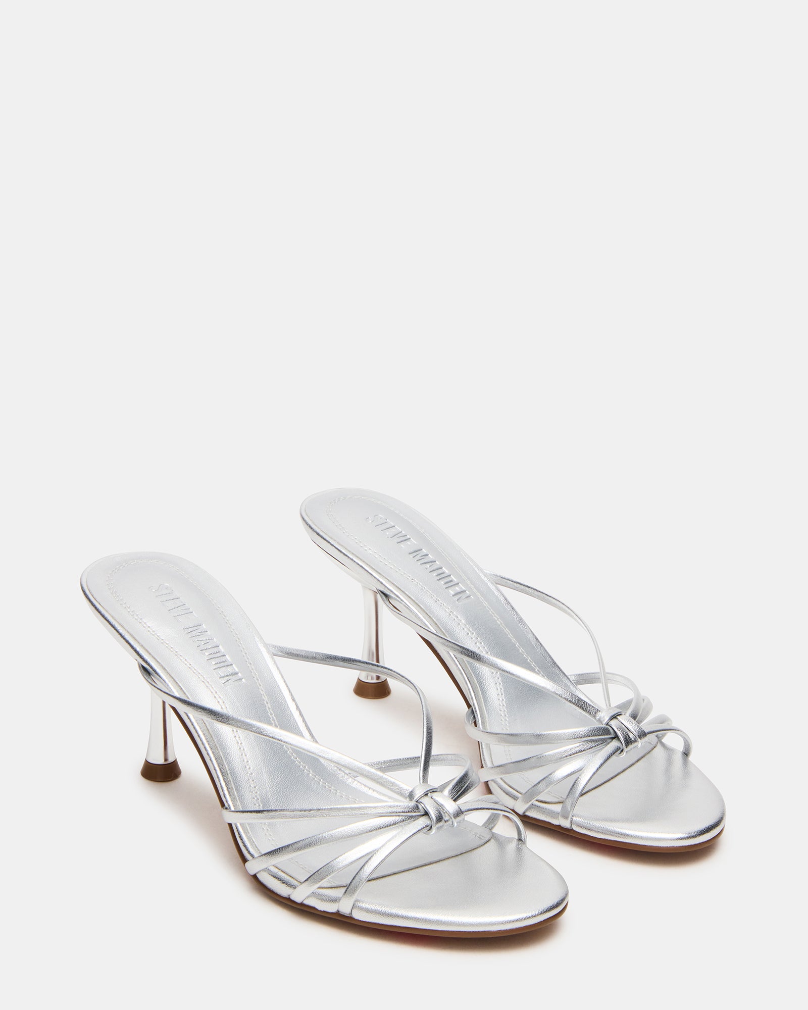 Top-down angle of mules heels highlighting strappy design and rounded toe