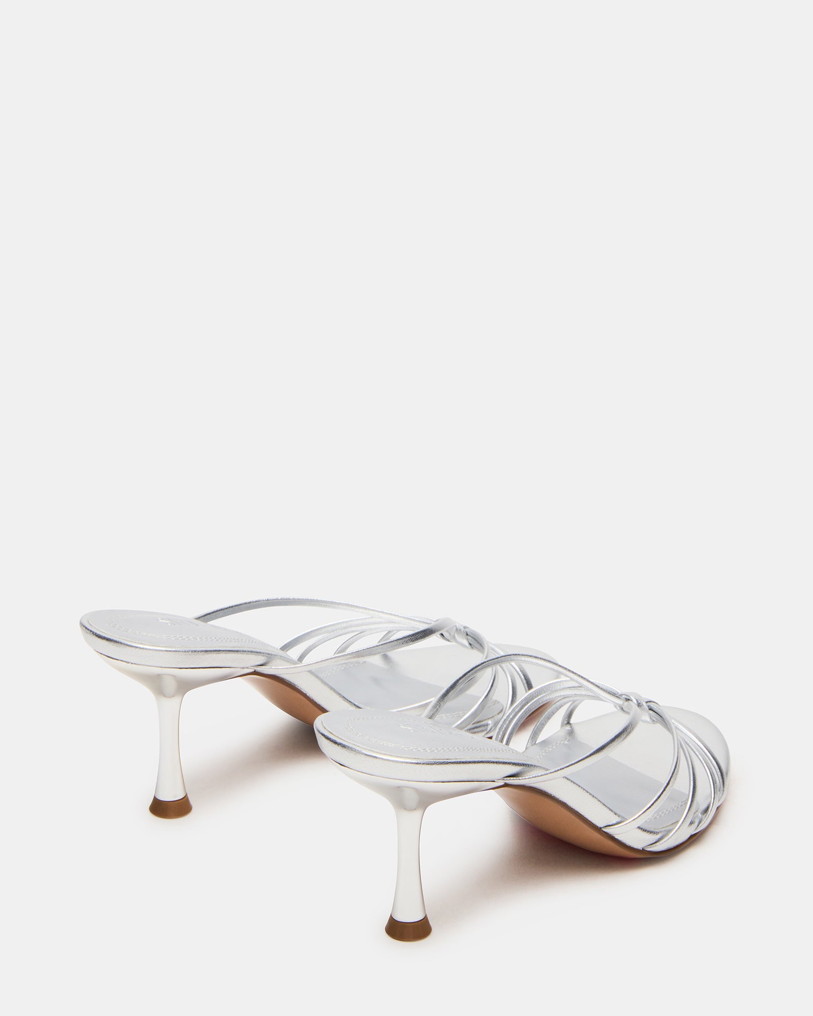 Top-down angle of mules heels highlighting strappy design and rounded toe