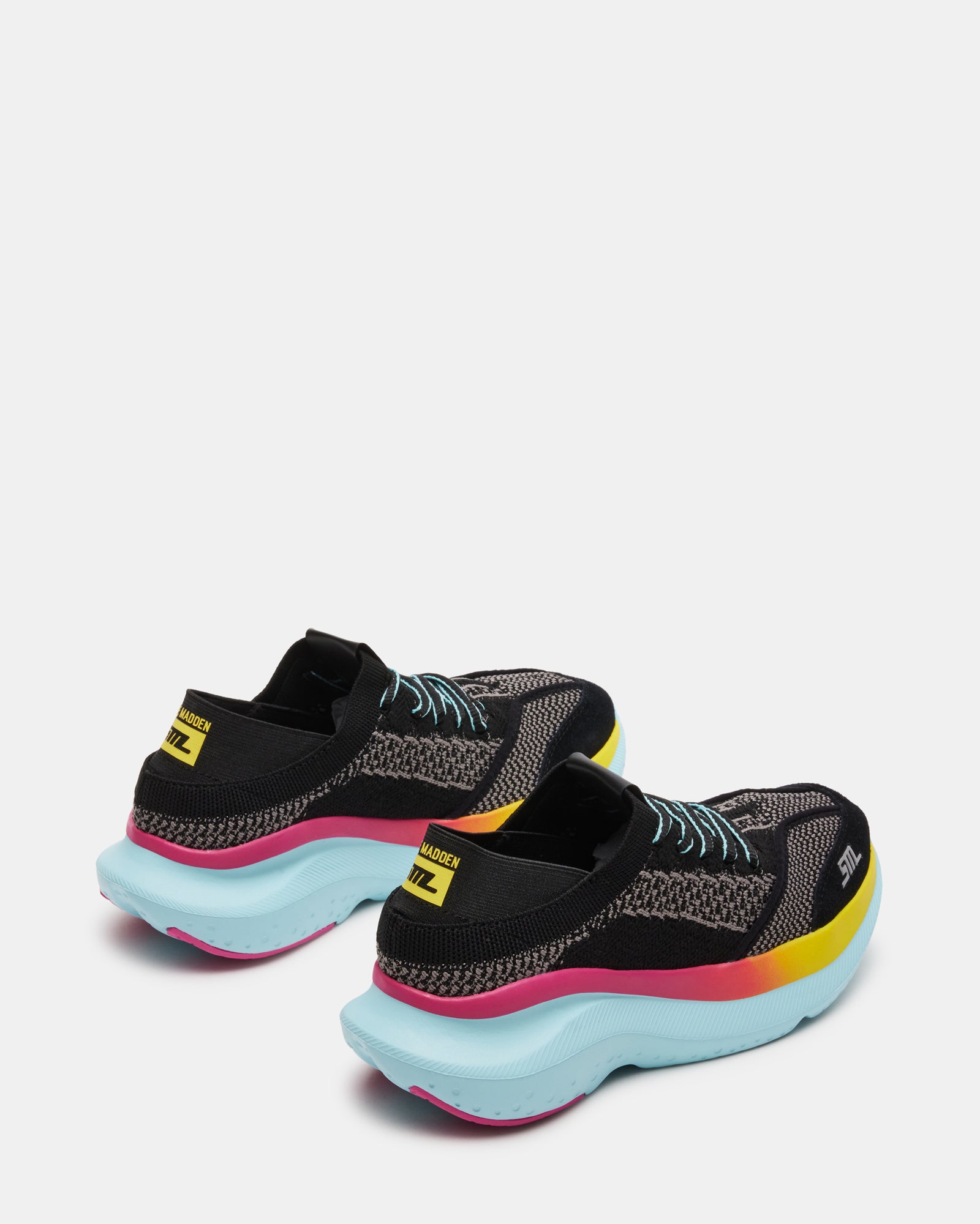 Lifestyle shot of black platform sneakers worn during a casual city stroll.