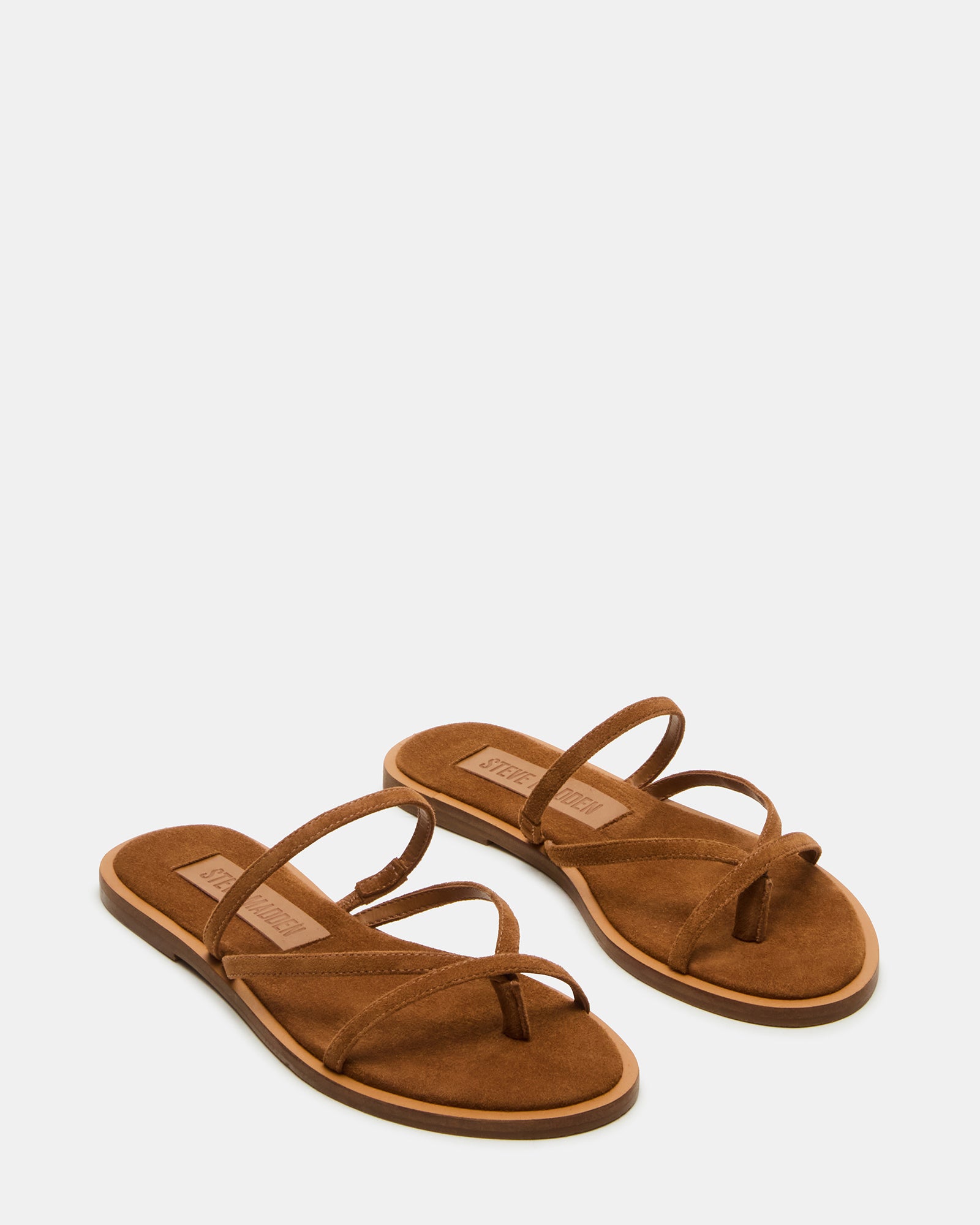 Model wearing ELLERY suede sandals paired with summer dress