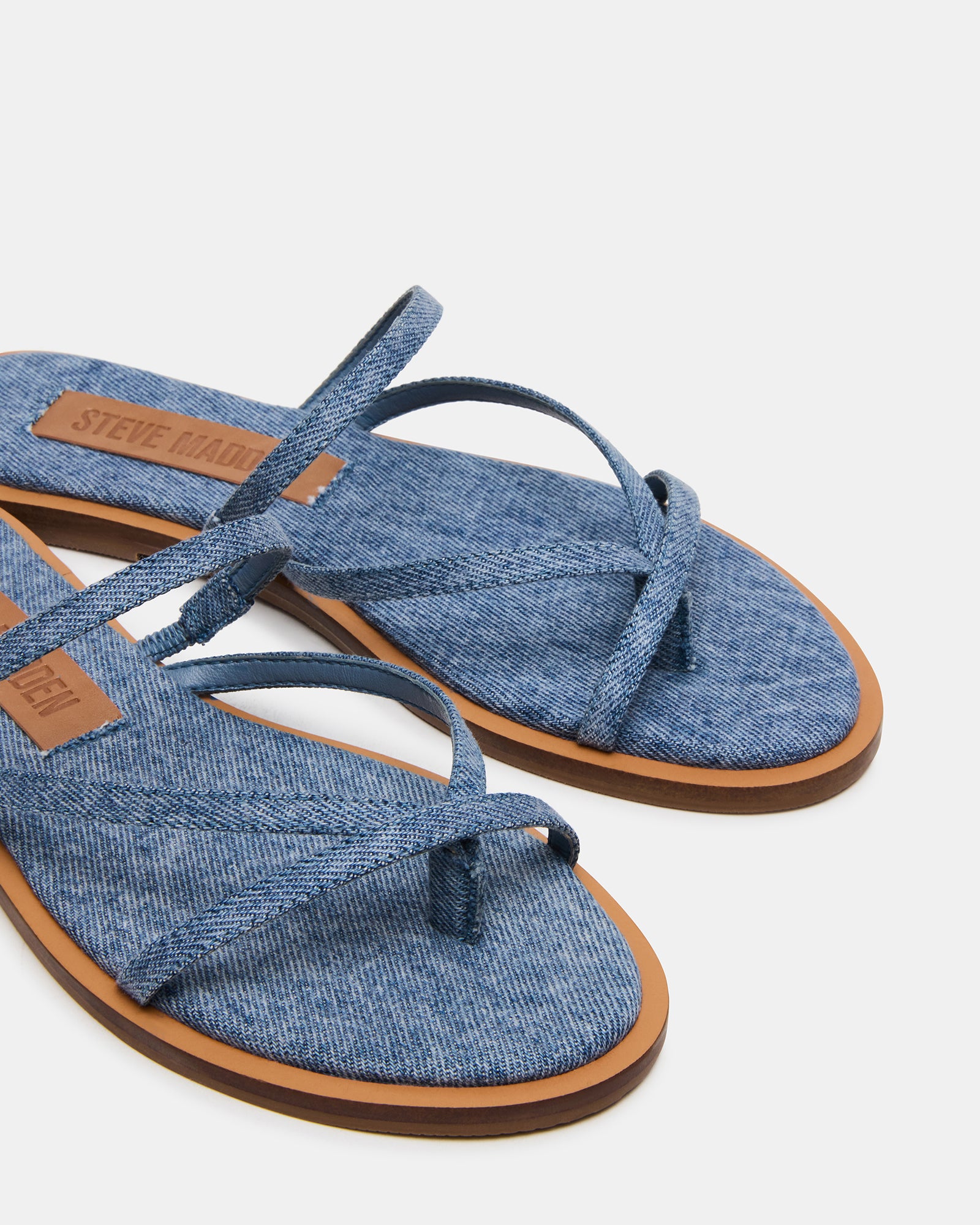 Pair of sandals on a beach towel showcasing their lightweight design