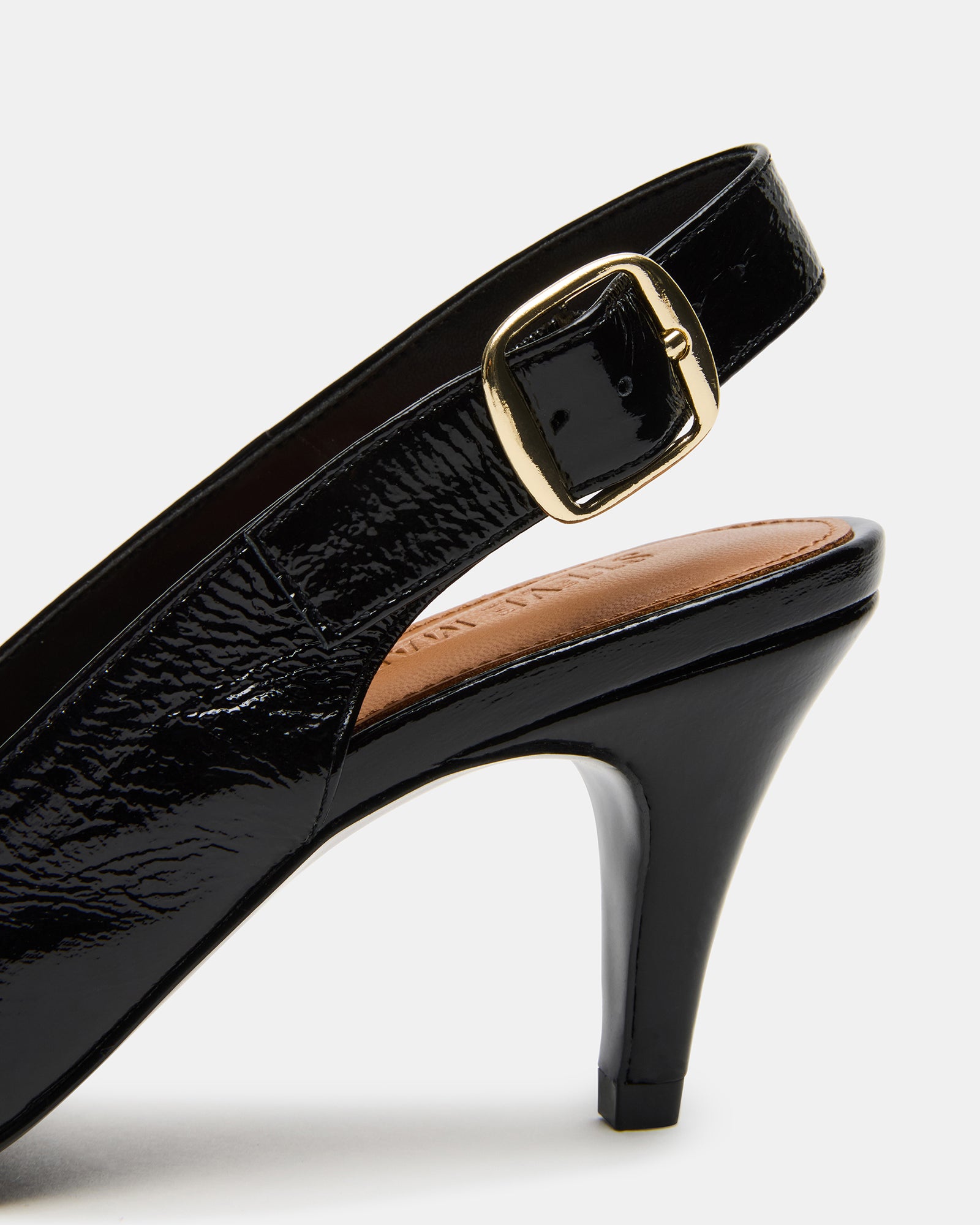Stylish woman wearing black leather pumps in city environment