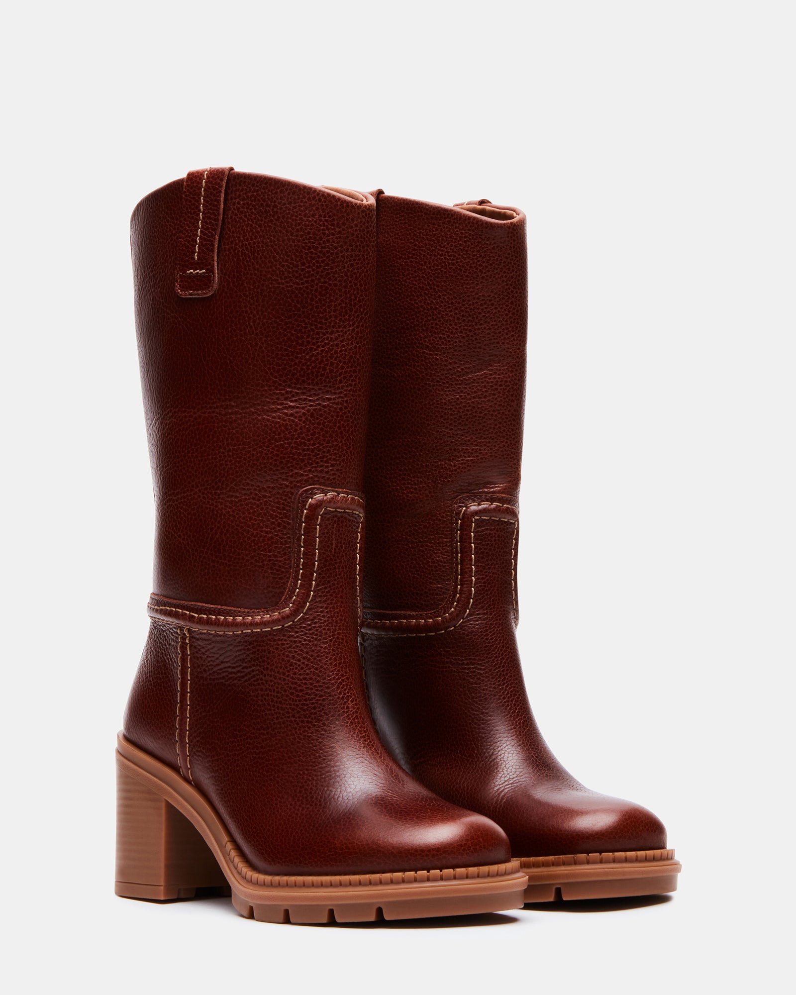 Close-up of platform heel and treaded sole on tan boots