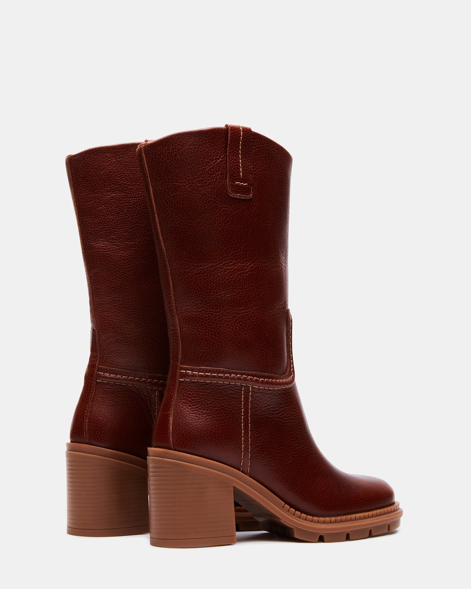 Close-up of platform heel and treaded sole on tan boots