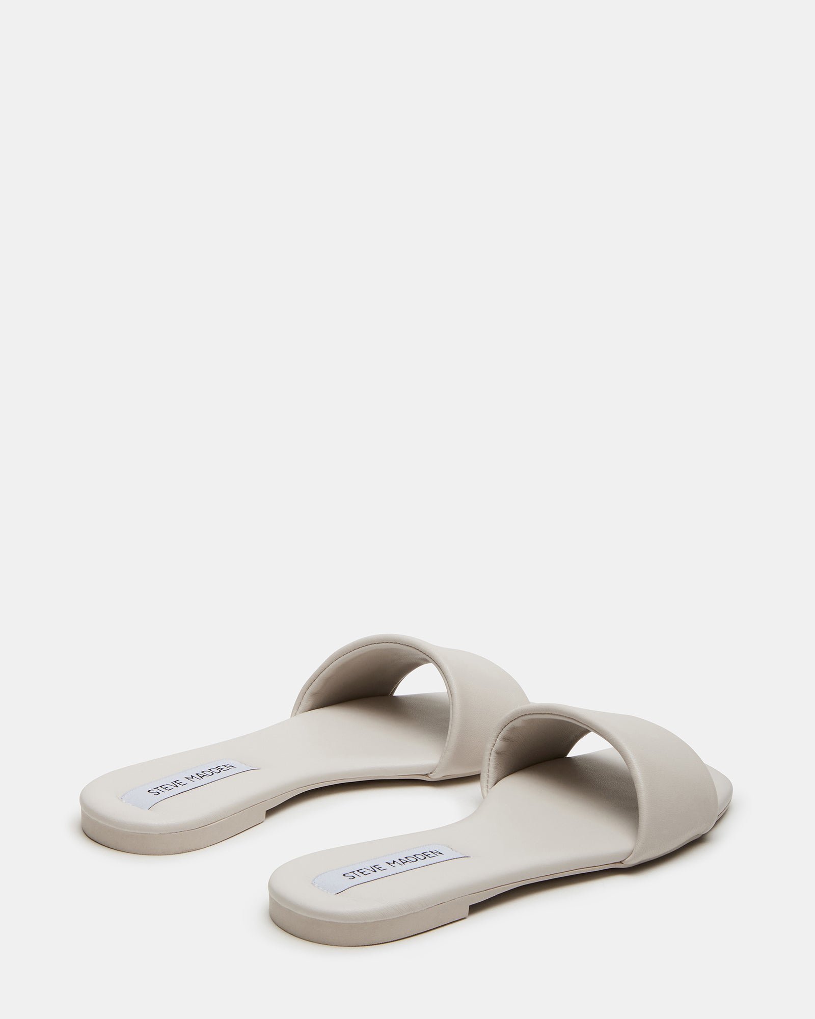 Woman wearing leather slides for casual outings, showcasing comfort