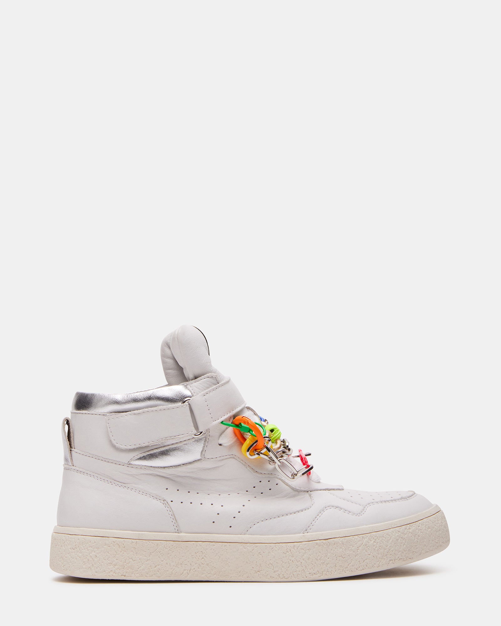 Side view of white platform sneakers showing perforated details and ankle strap
