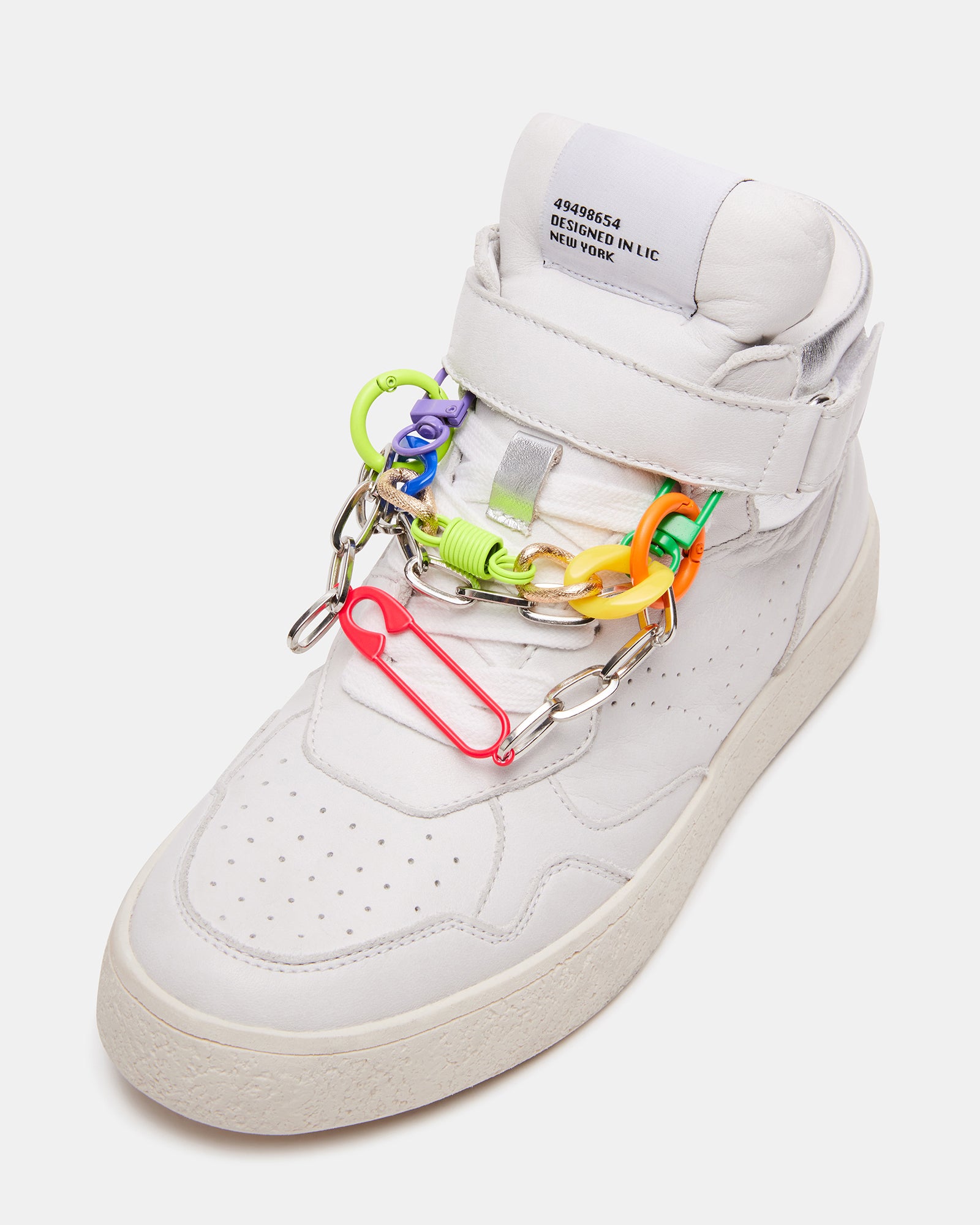 Side view of white platform sneakers showing perforated details and ankle strap