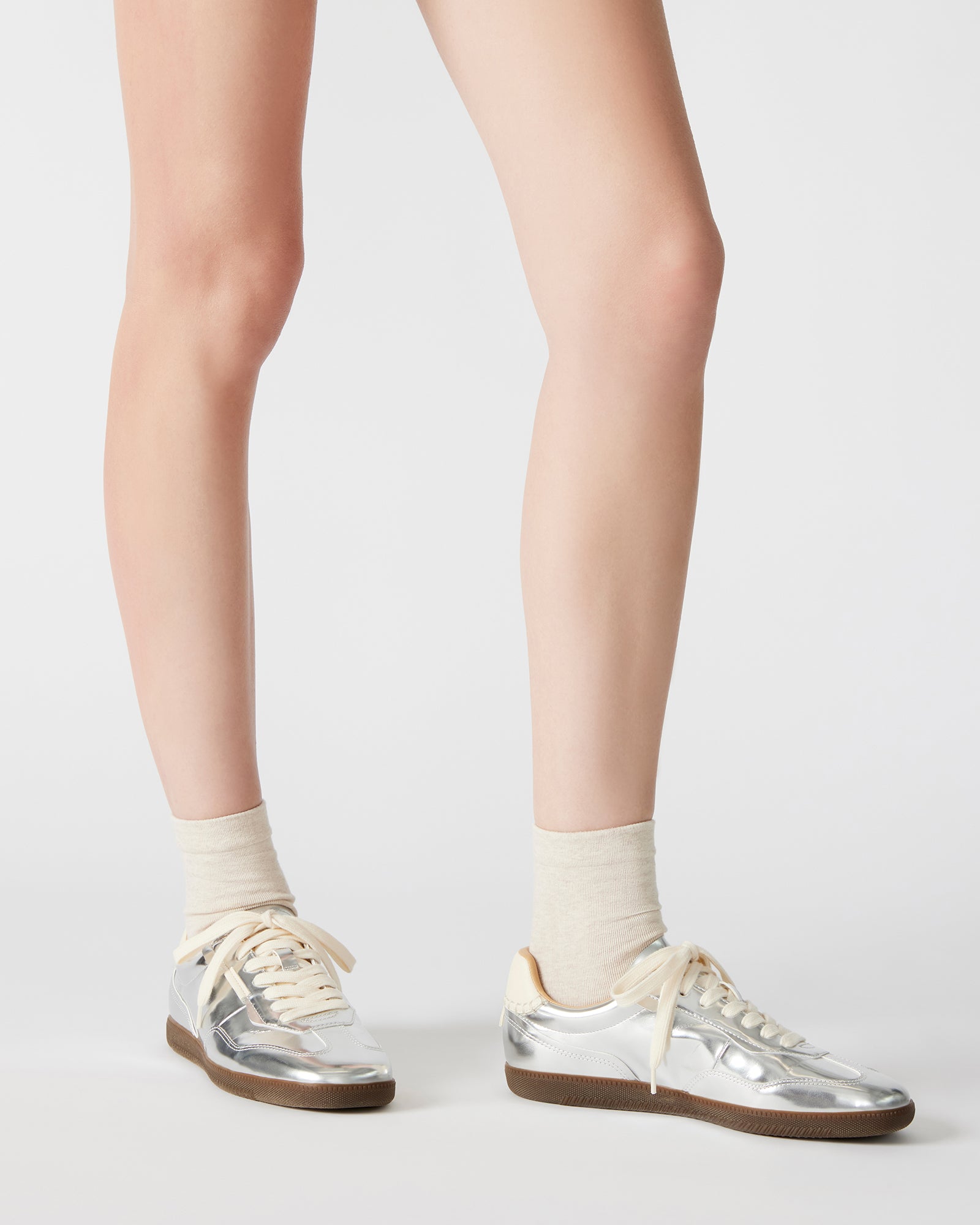 Close-up of laced closure on womens velvet sneakers.