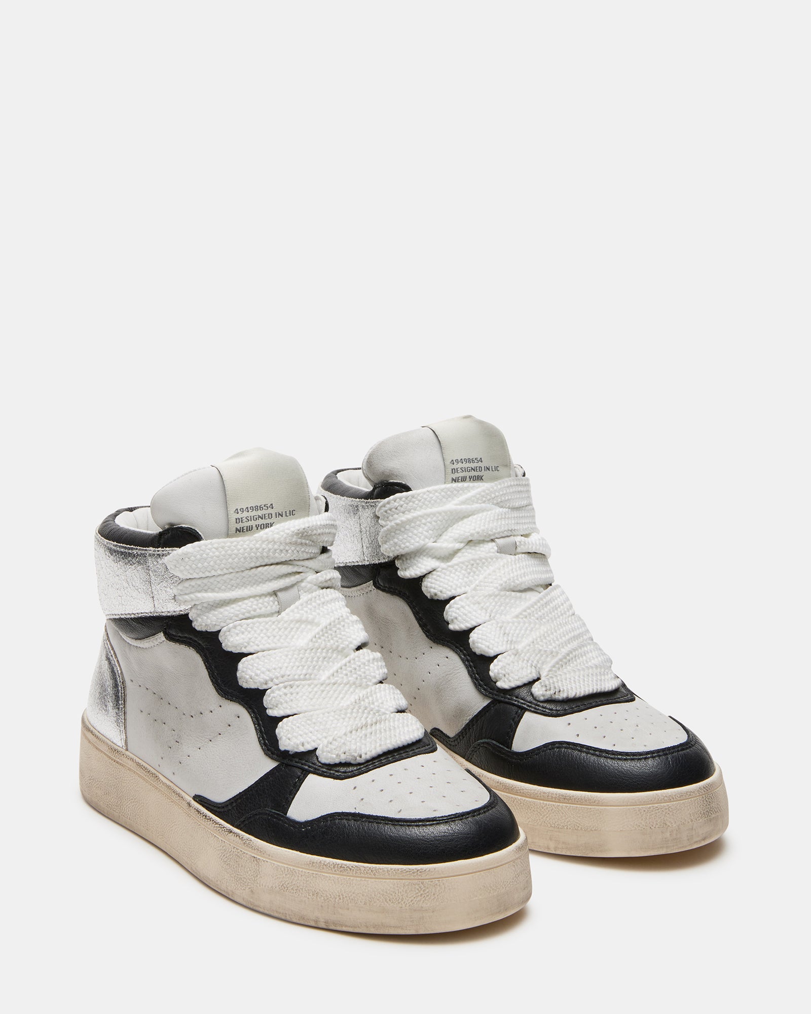 Side angle showing the distressed design of white platform sneakers