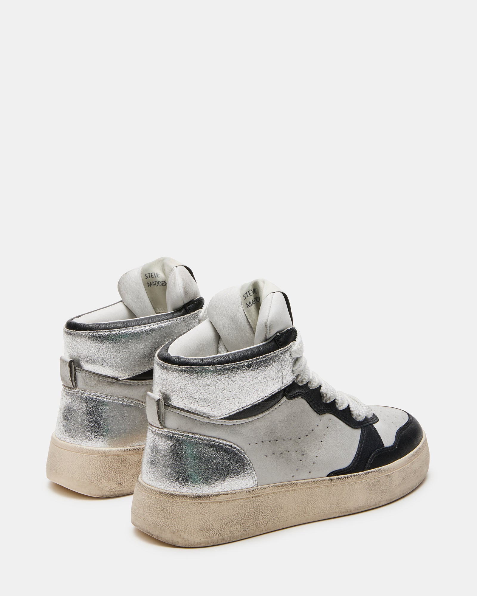 Side angle showing the distressed design of white platform sneakers