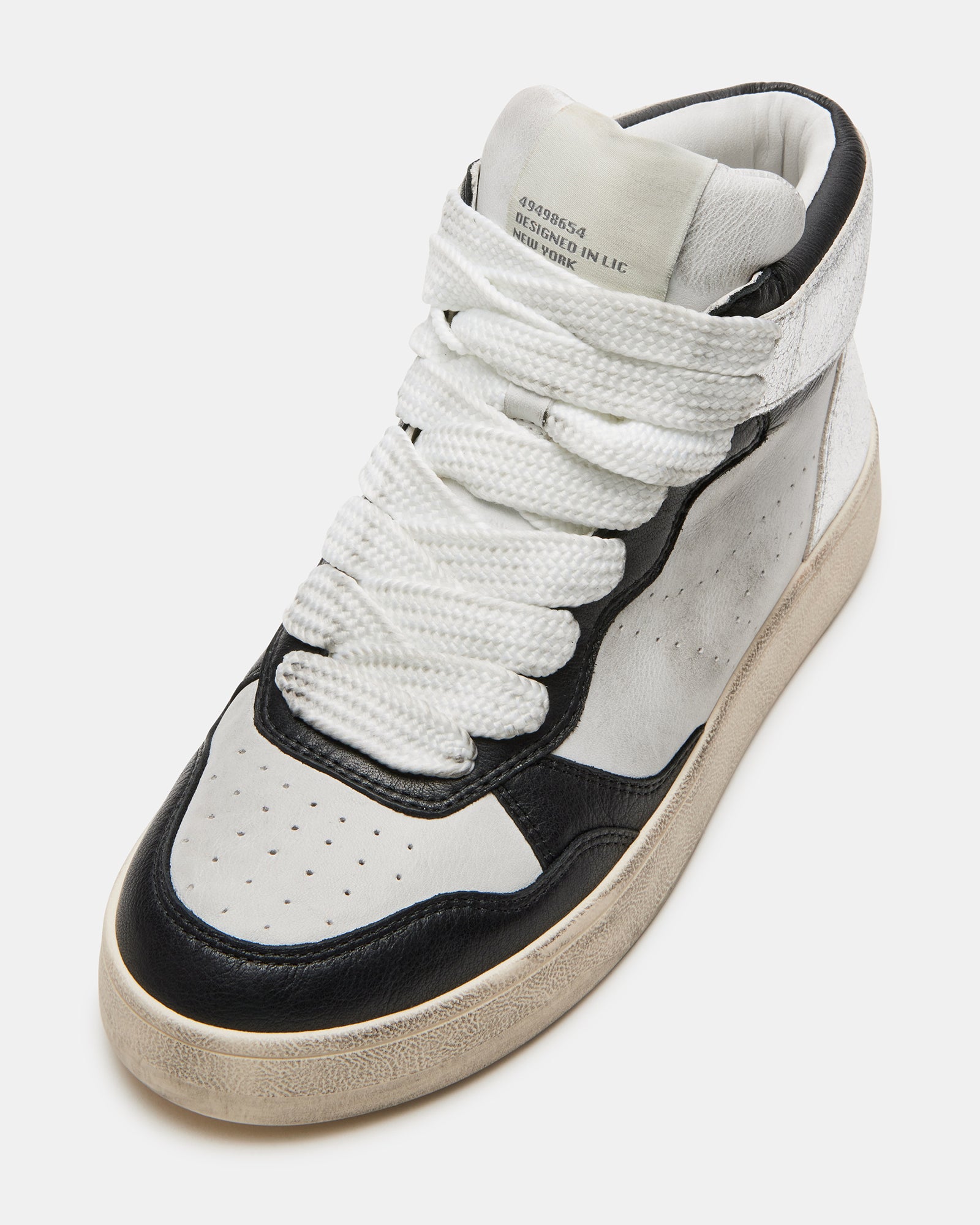 Close-up of laces and perforated details on high top shoes