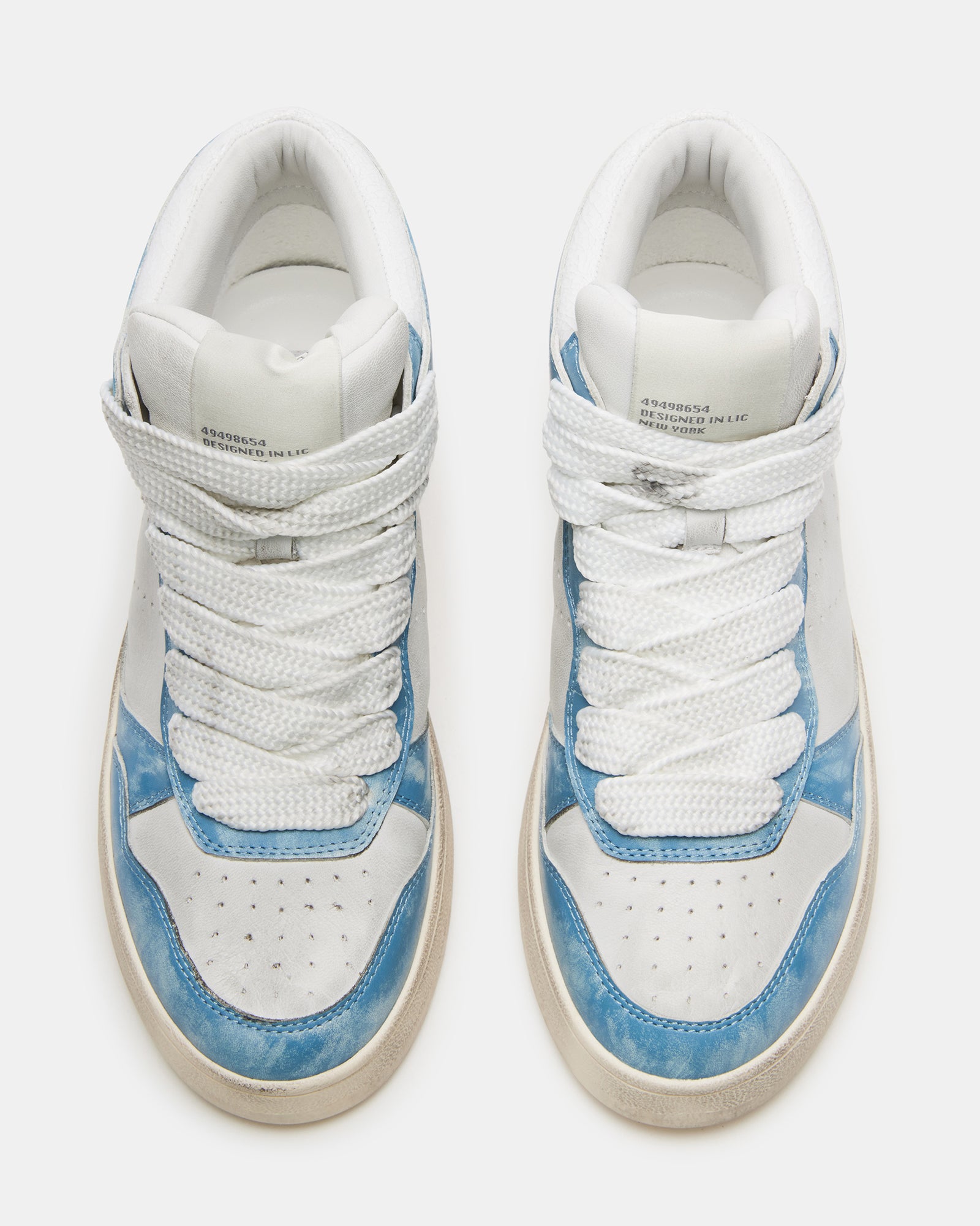 Side view of distressed high top sneakers with wide laces and platform sole