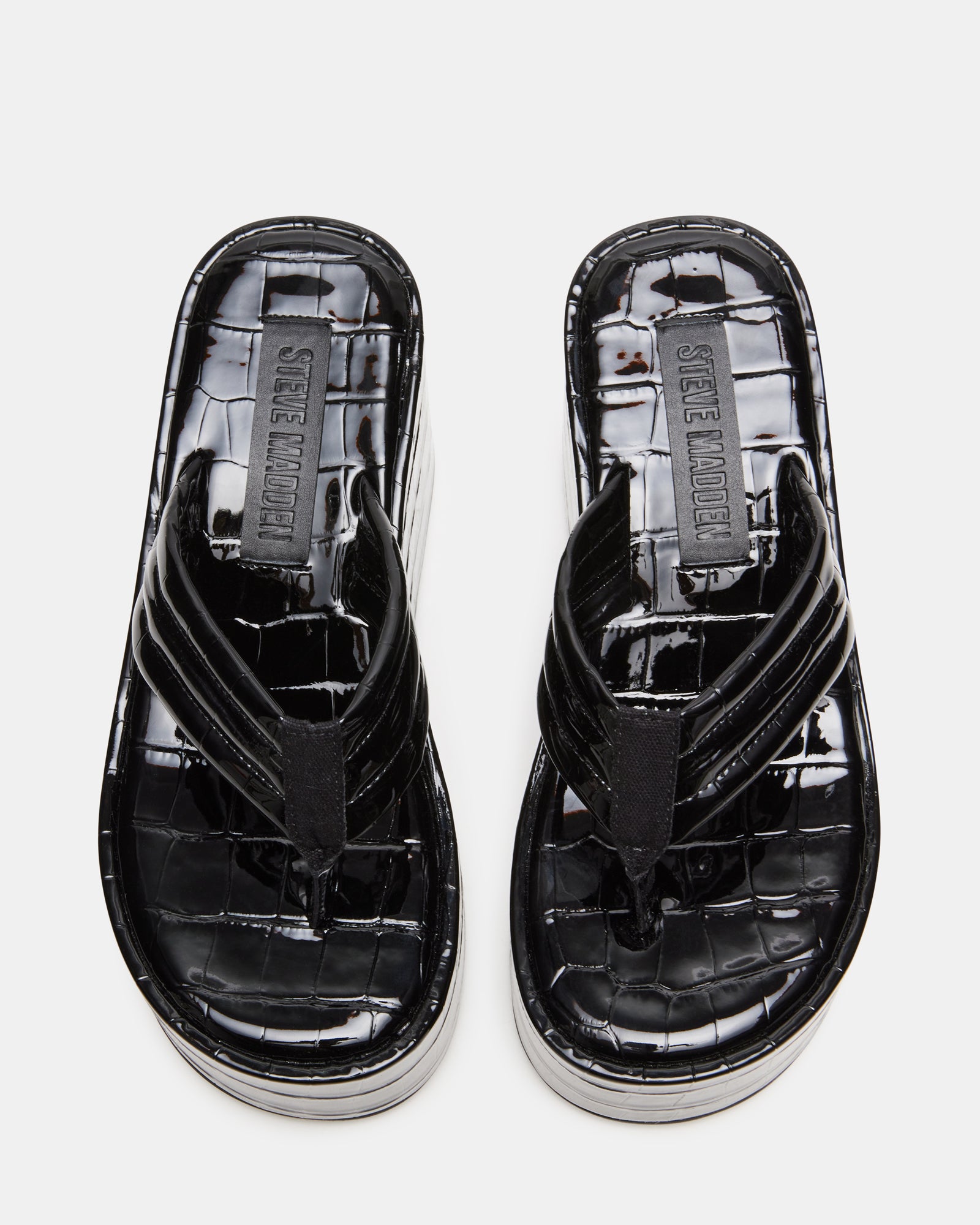 Side view of black platform sandals showcasing the sleek design.