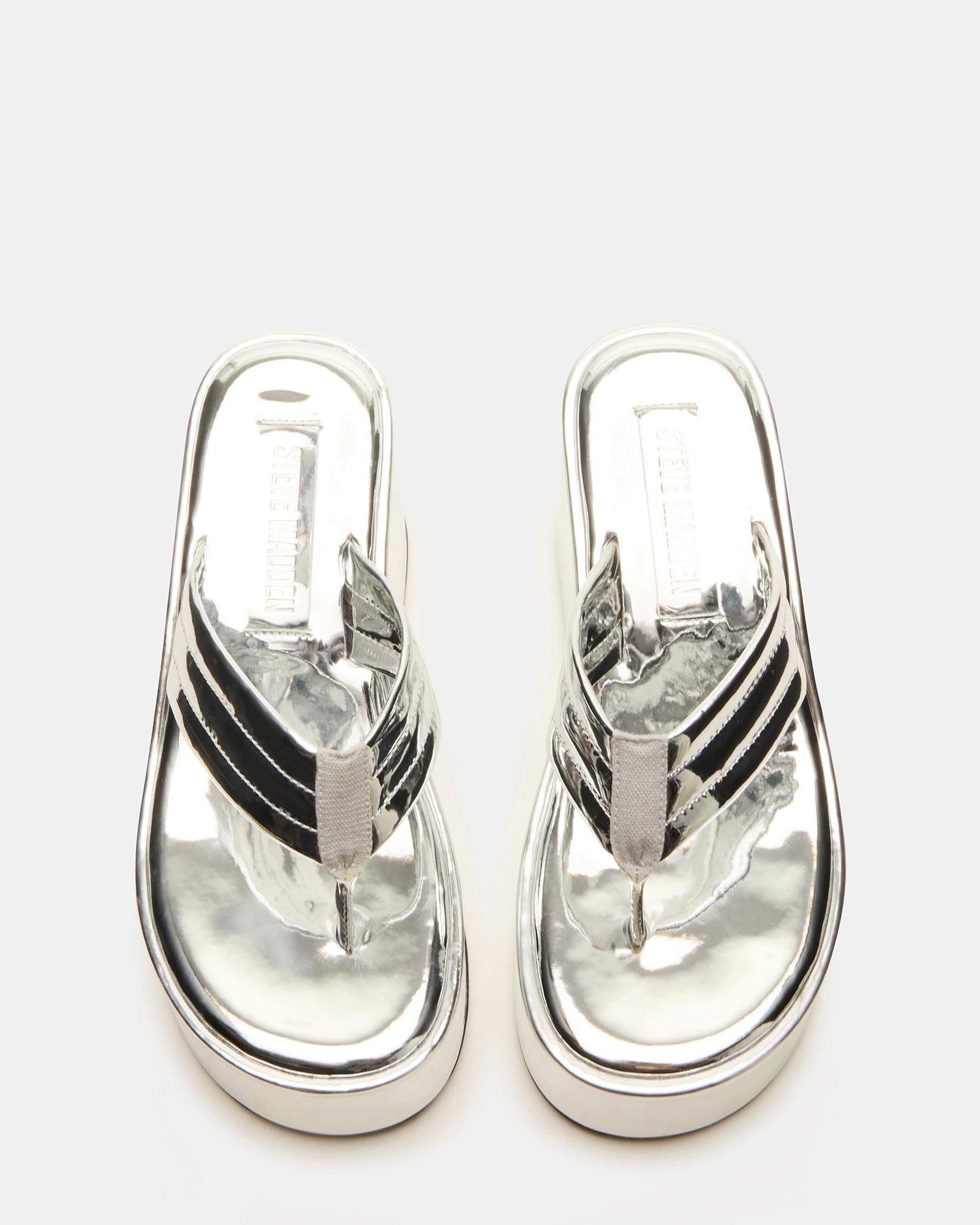 Side view of silver wedge sandals with platform for women