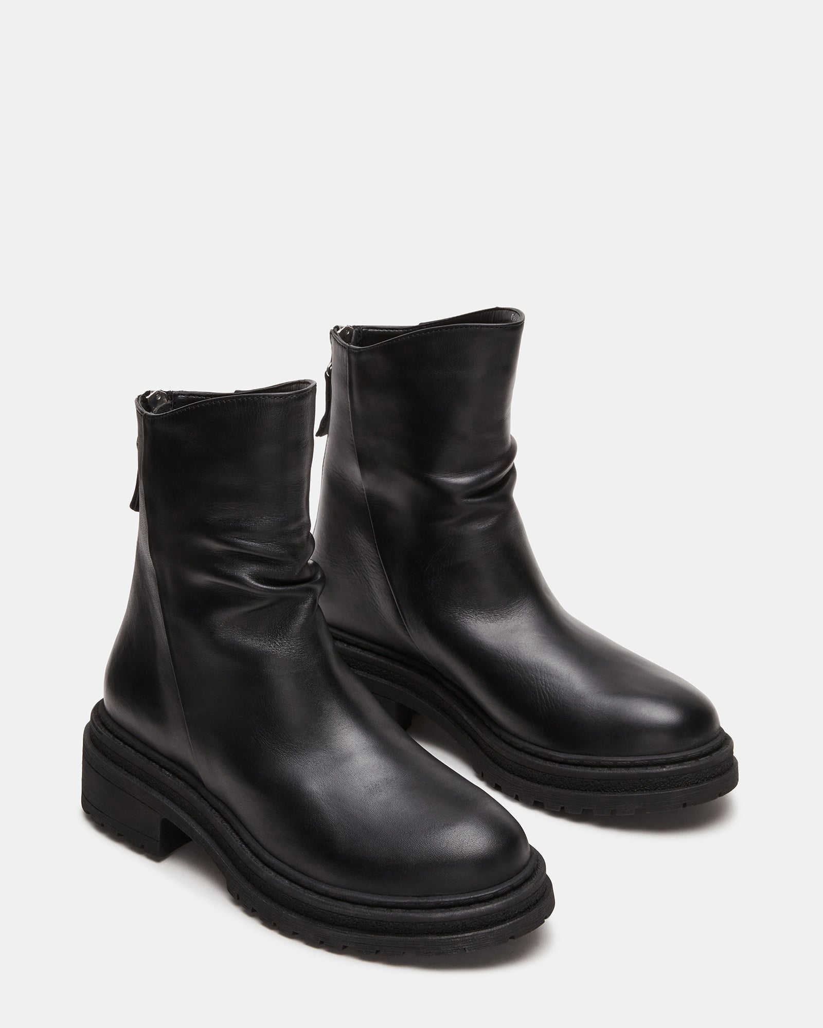 Close-up of the scrunched design and rounded toe of the black ankle boots.