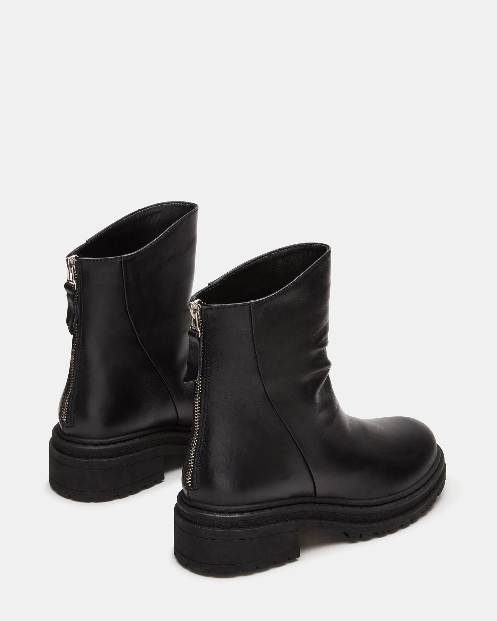 Close-up of the scrunched design and rounded toe of the black ankle boots.