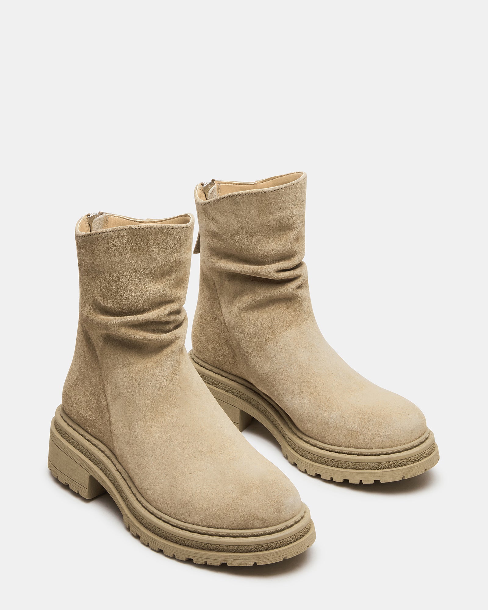 Close-up of the rounded toe on taupe suede ankle boots.