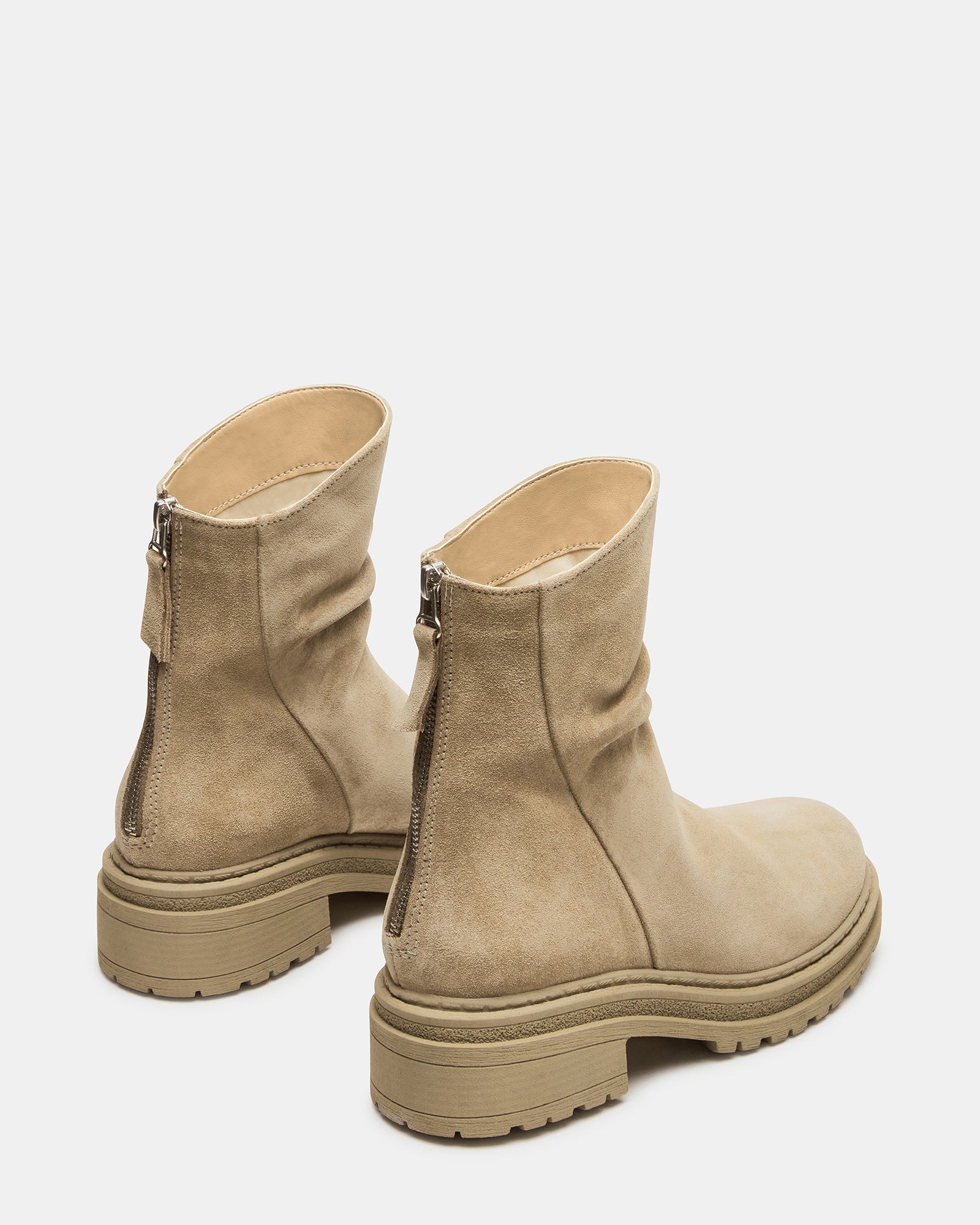 Close-up of the rounded toe on taupe suede ankle boots.