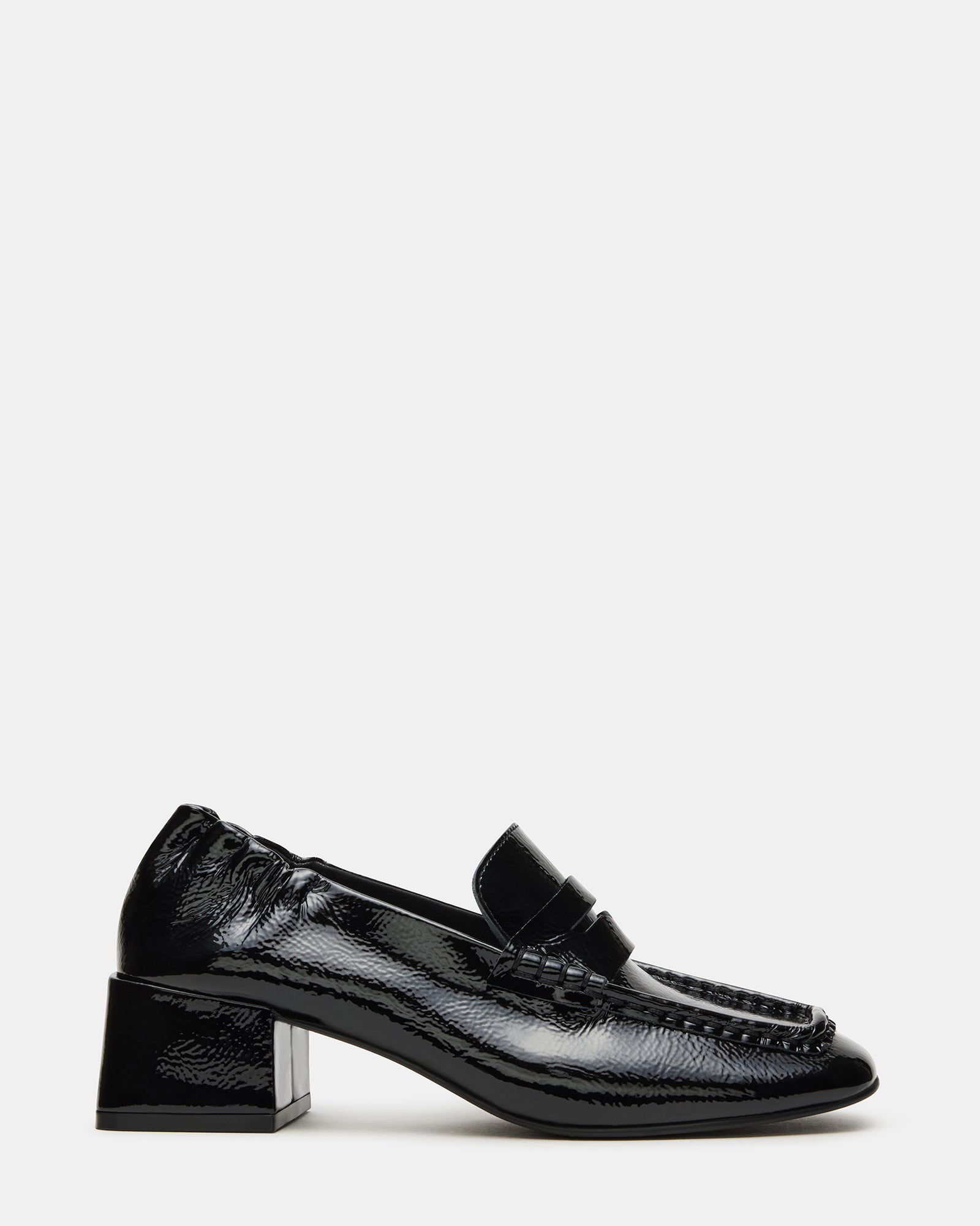 Close-up of black crinkle patent loafers highlighting the square toe design
