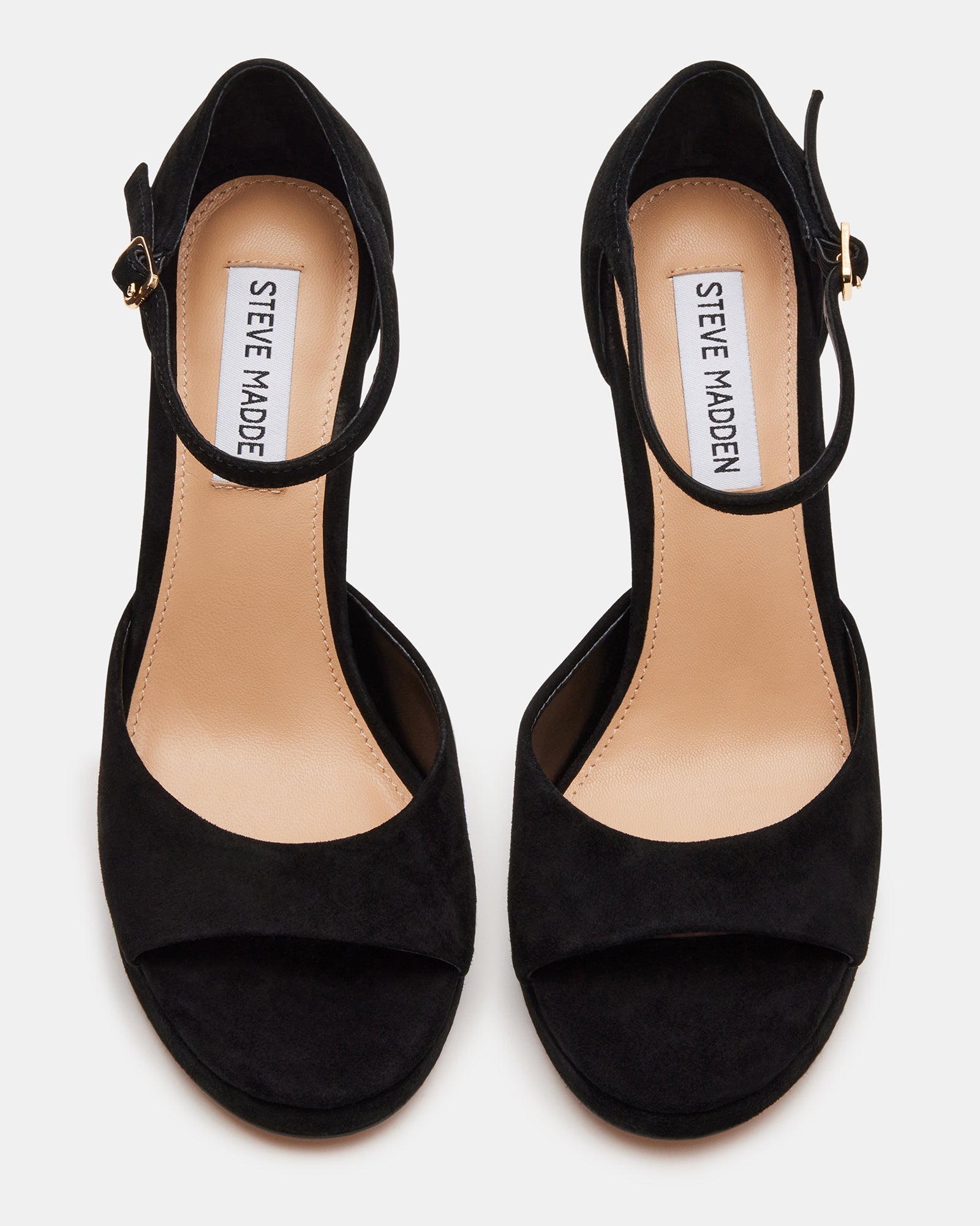 Close-up of black heels showcasing suede texture and ankle strap design