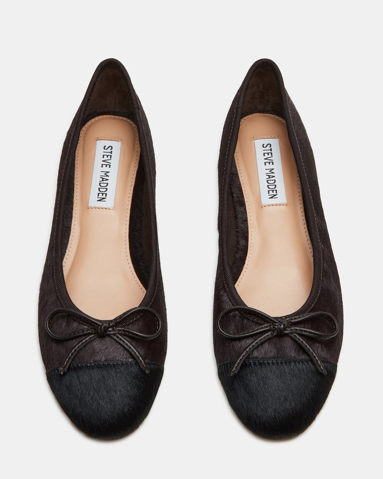 Black ballet flats with a side view showing the bow detail.