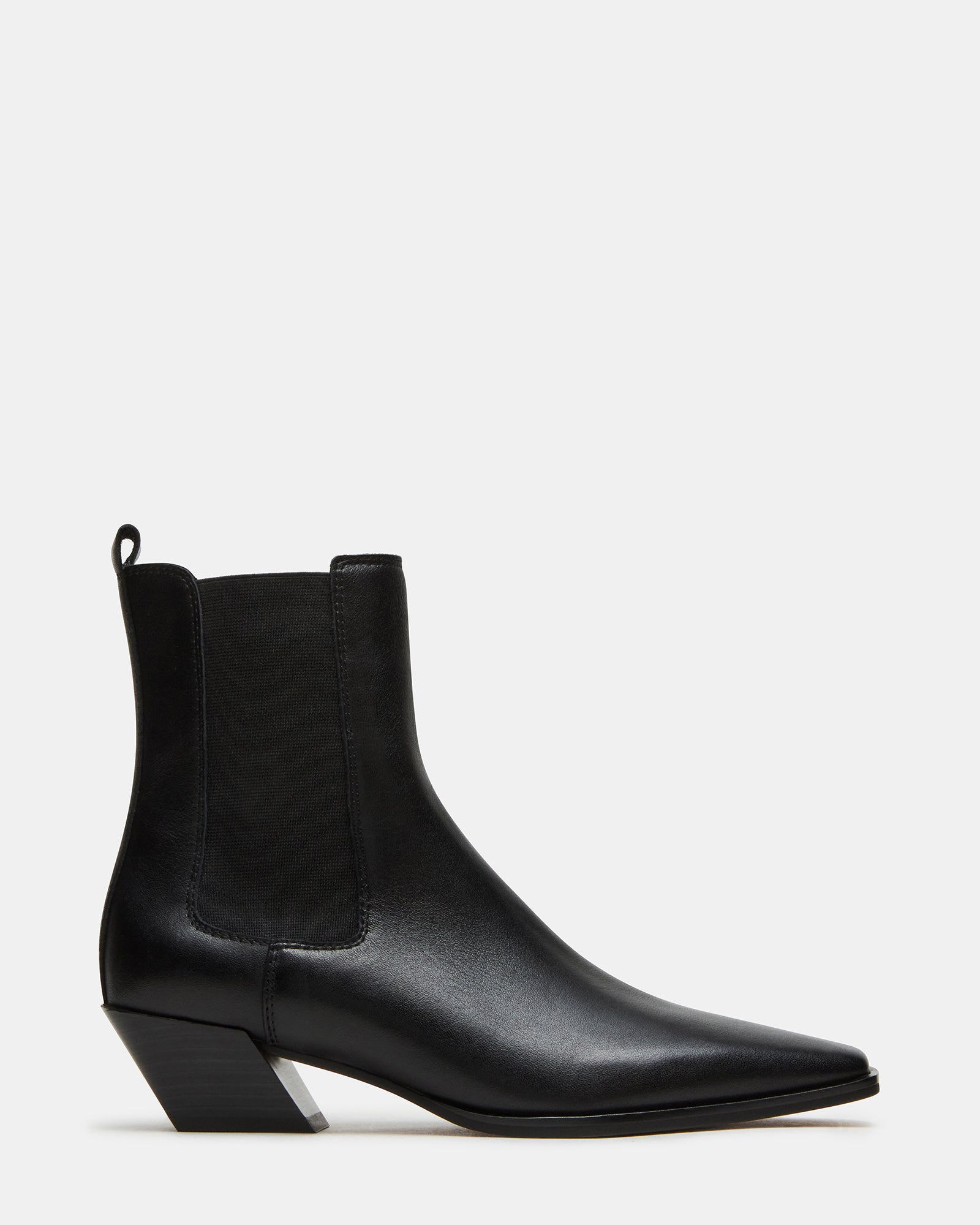 Black Chelsea boots styled with cuffed jeans for a casual look.
