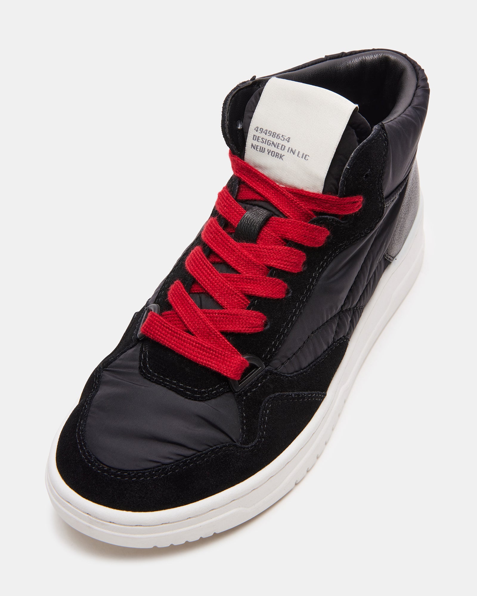Everett Black Multi platform sneakers on a city sidewalk