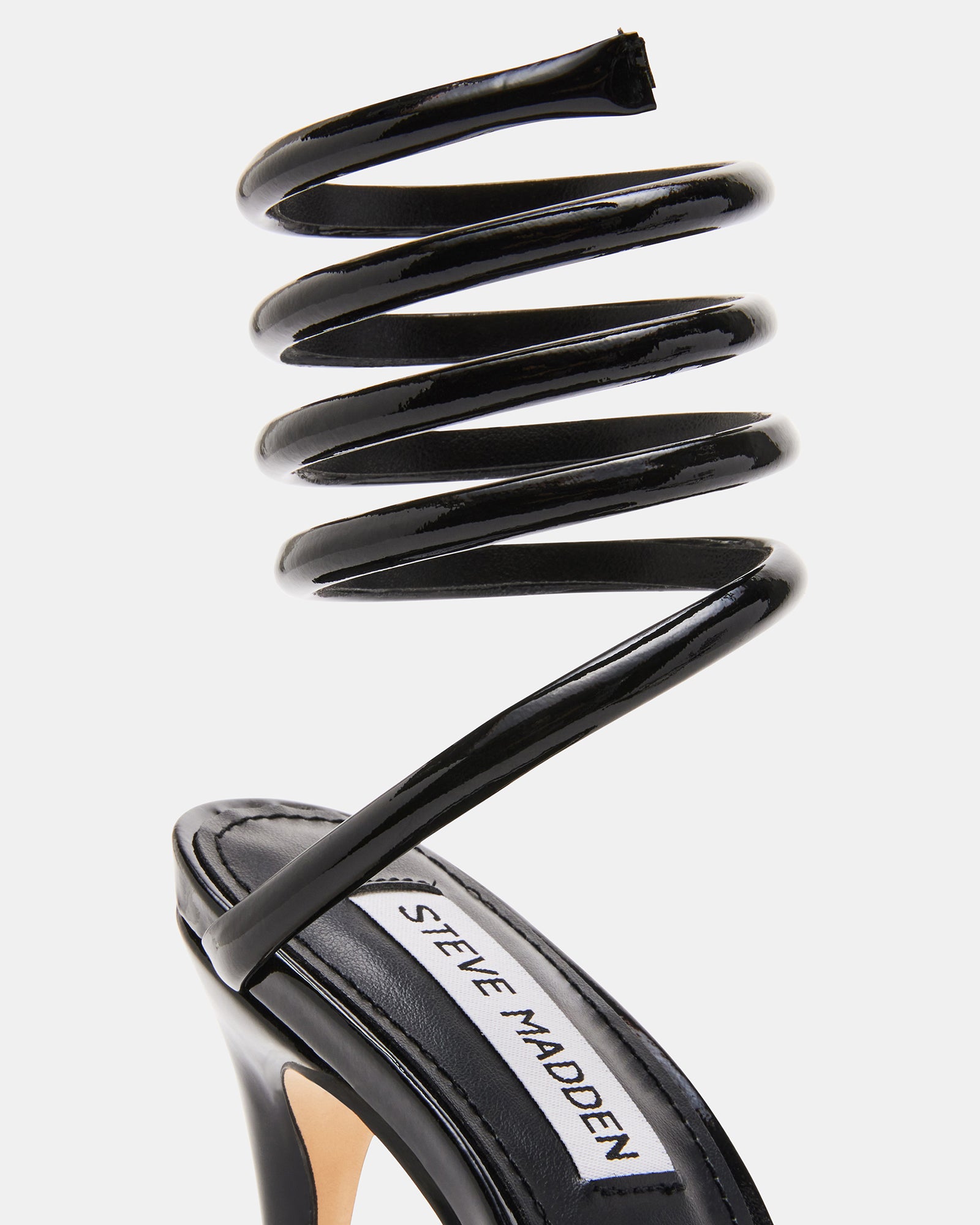 Elegant Exotica black patent leather pumps showcasing stiletto heels.