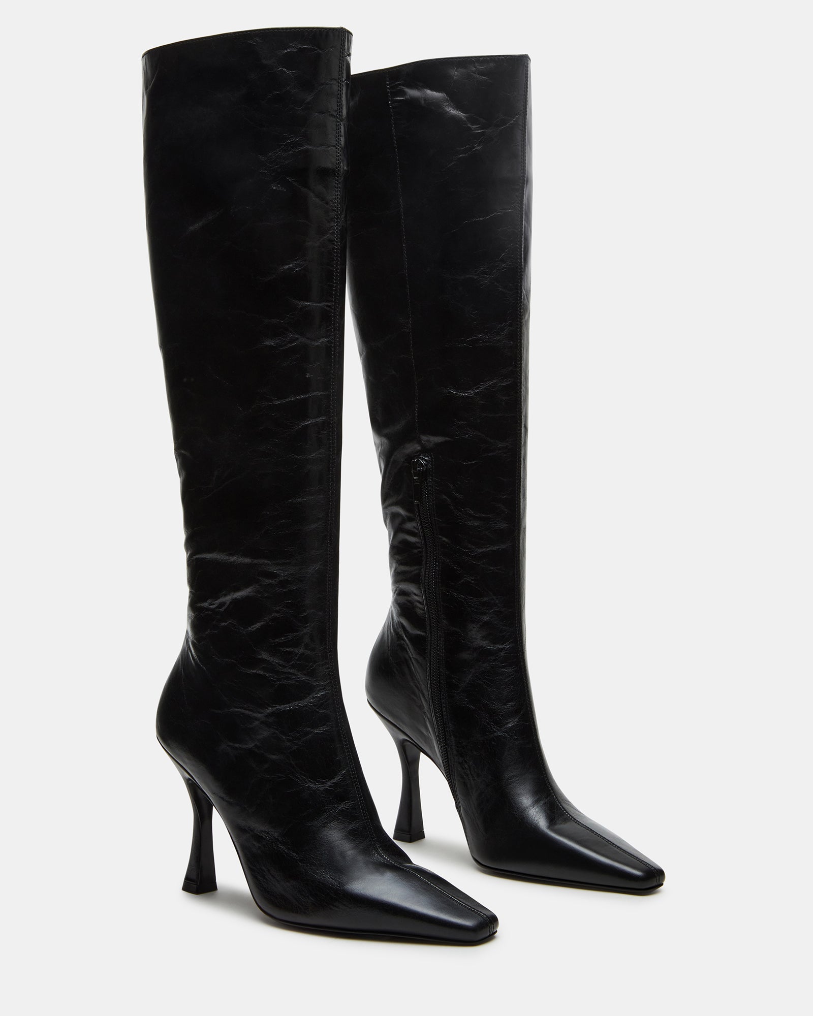 Faye Elegance black leather knee-high boots styled with a casual outfit.