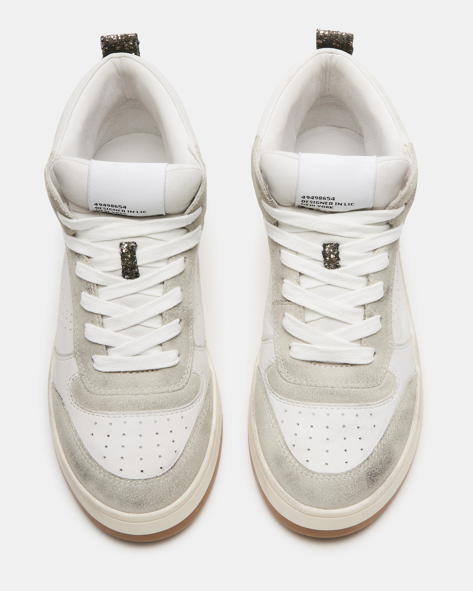 Side angle of the white leather high top sneakers with distressed sole, styled for urban wear.