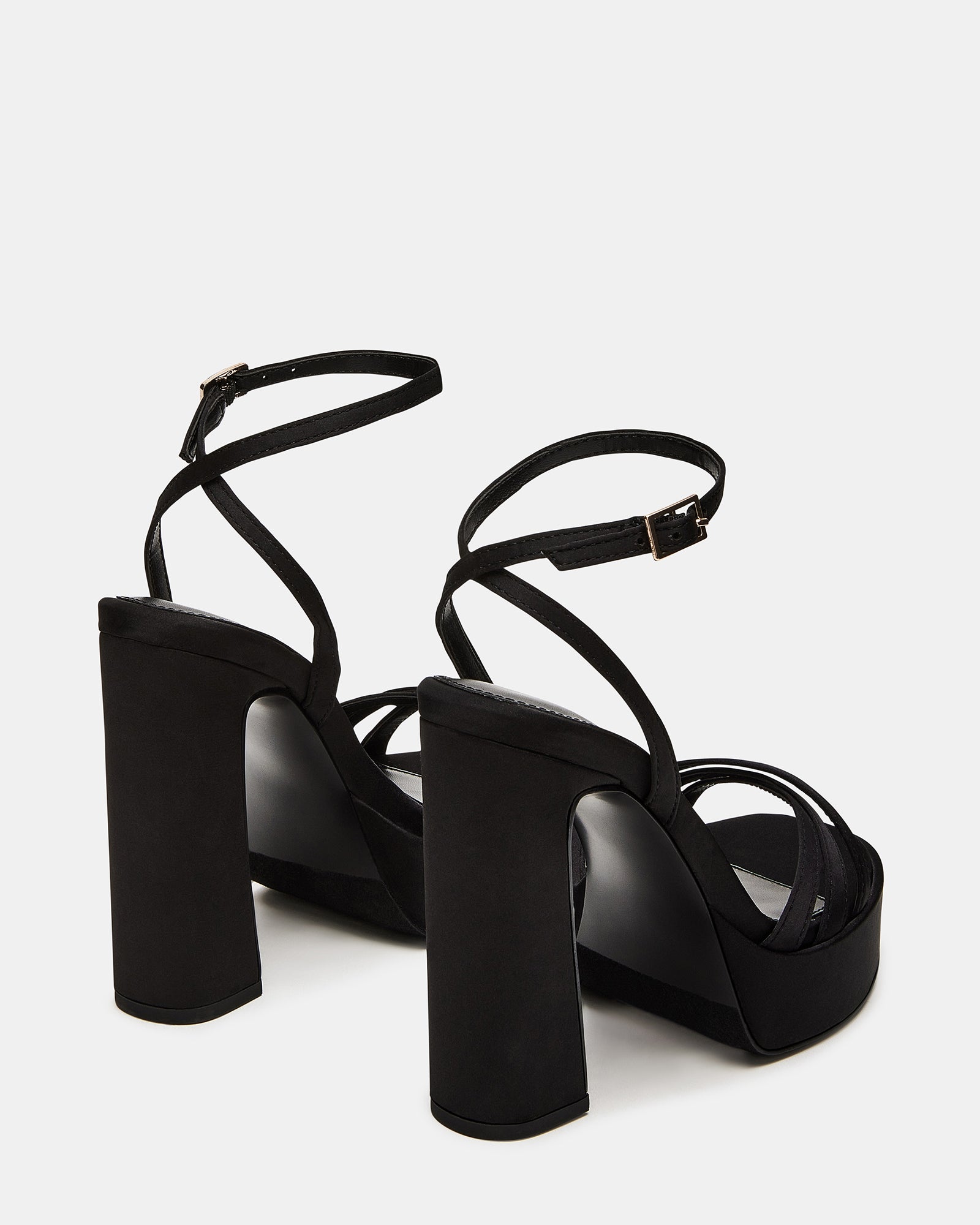Fleet black strappy sandals worn casually for a stylish day out.