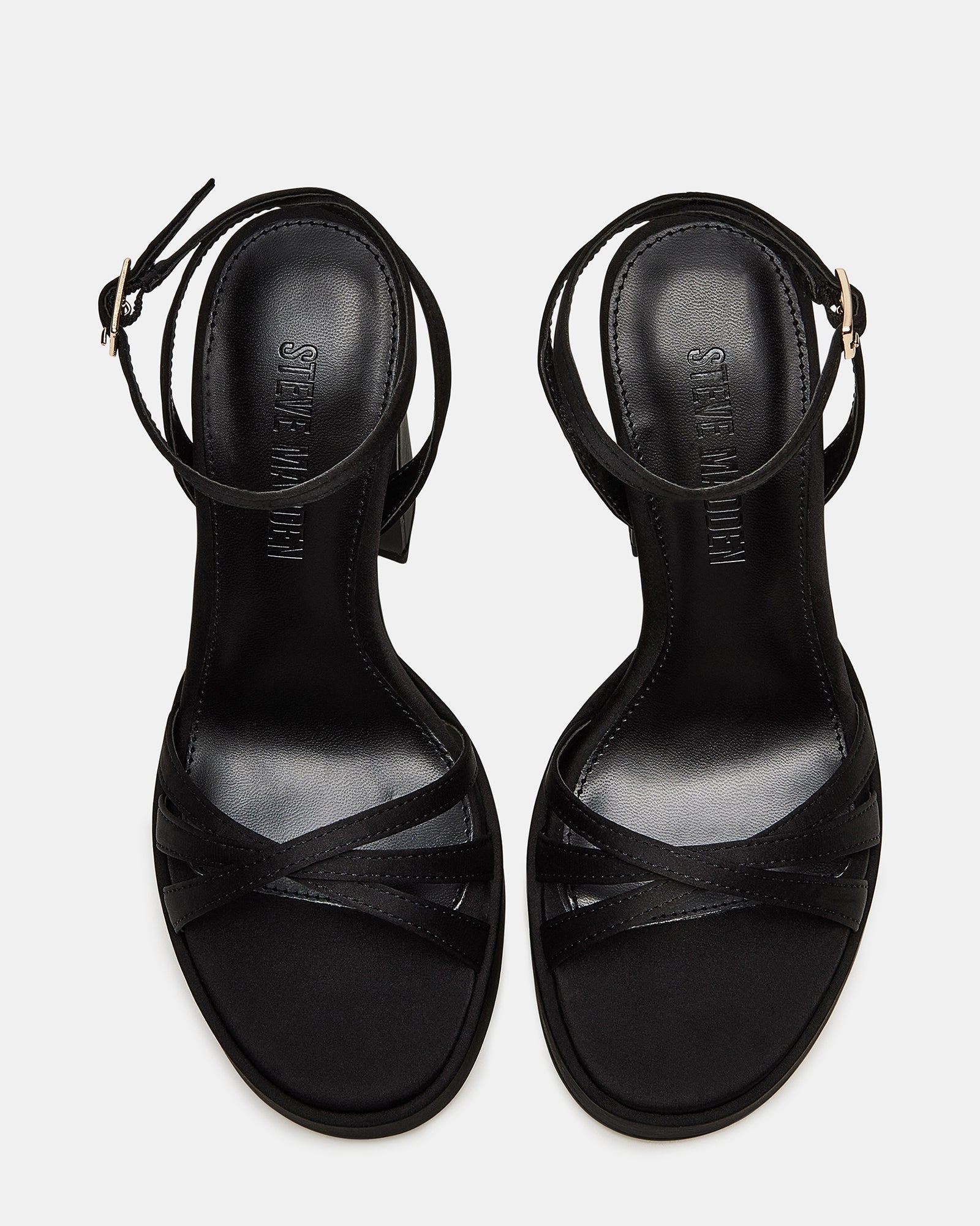 Close-up of Fleet black platform heels highlighting the ankle strap and texture.