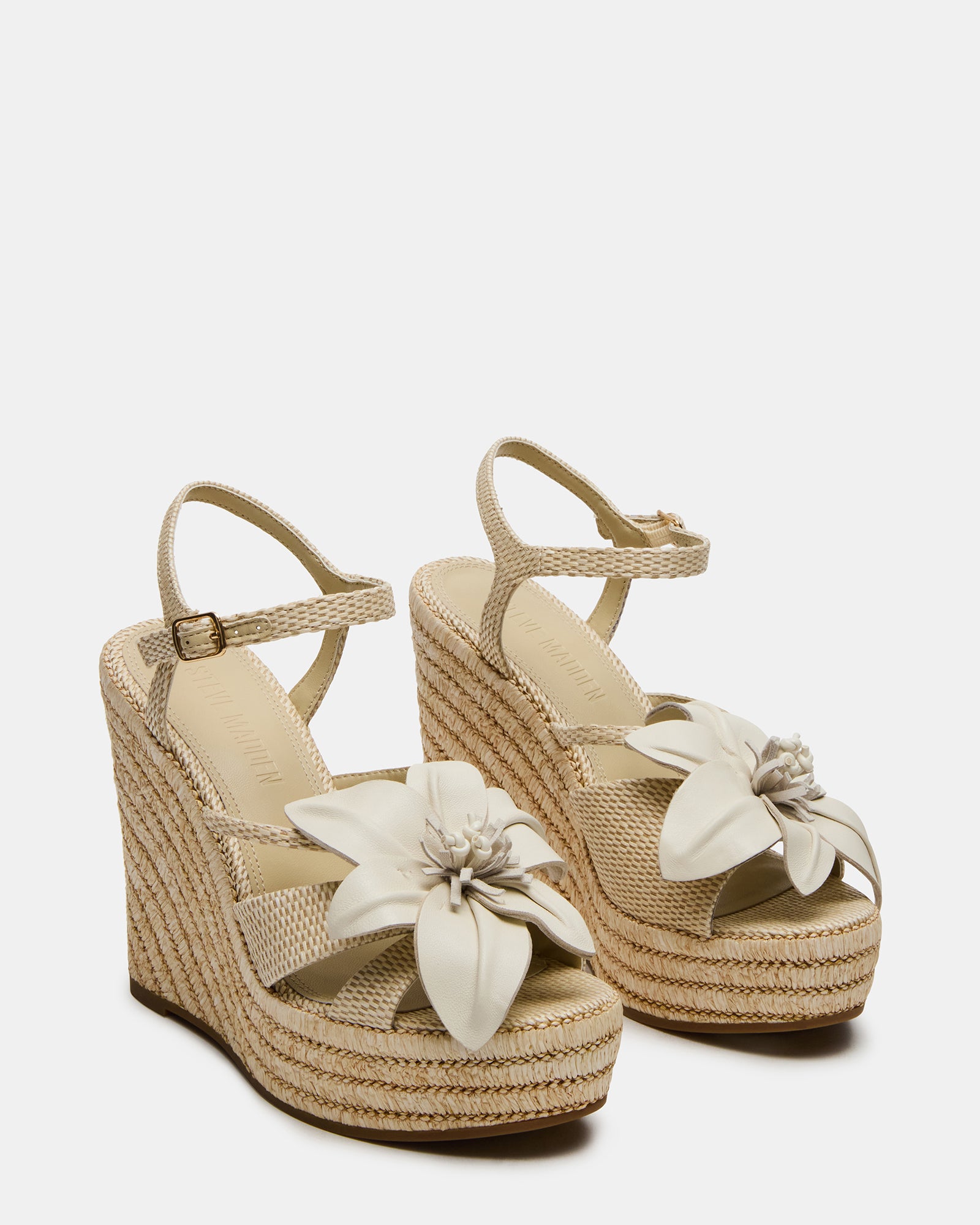 Side view of black platform wedge sandals with ankle strap, perfect for a summer day out.
