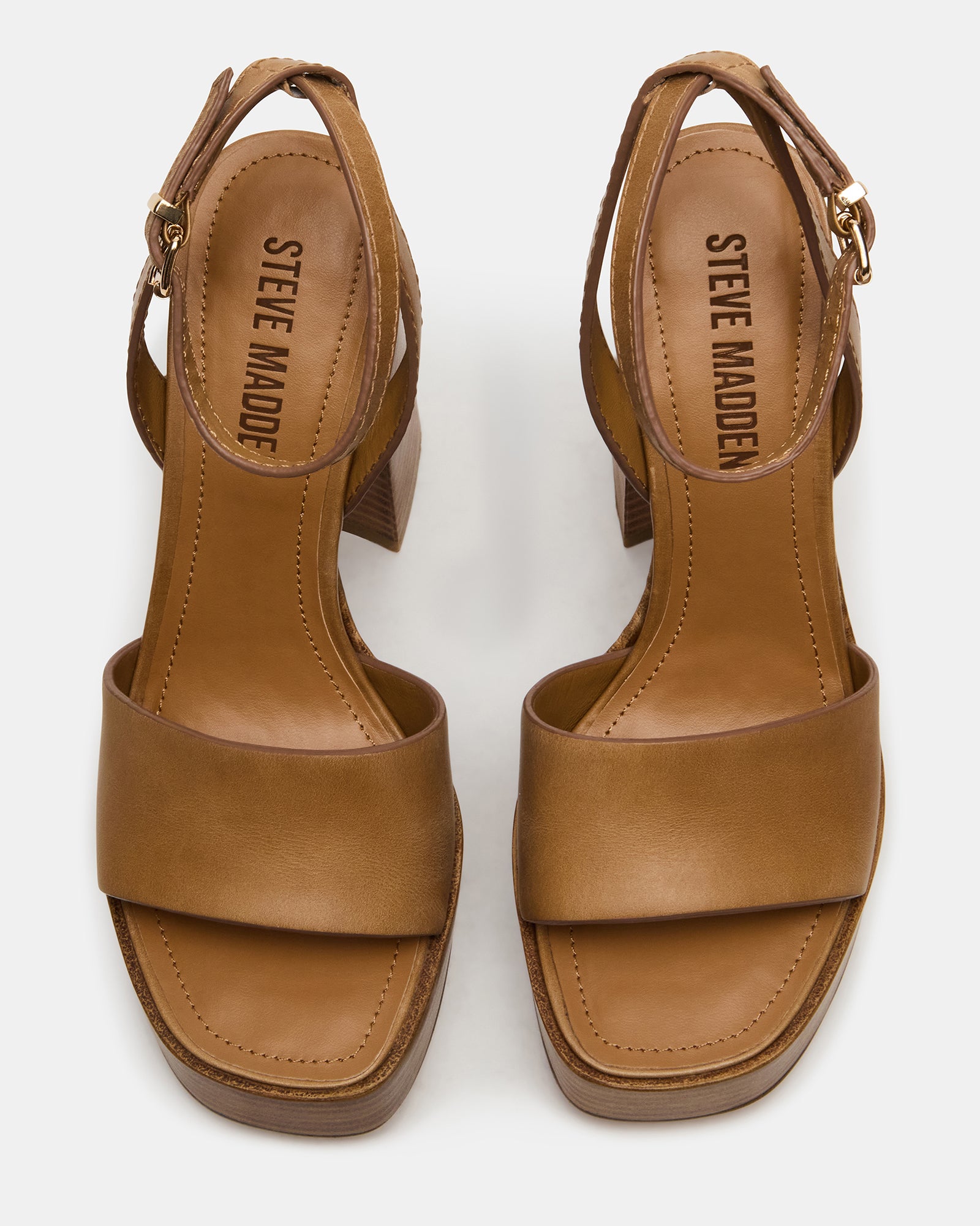 Brown leather heels showcasing the strappy design and platform block heel.
