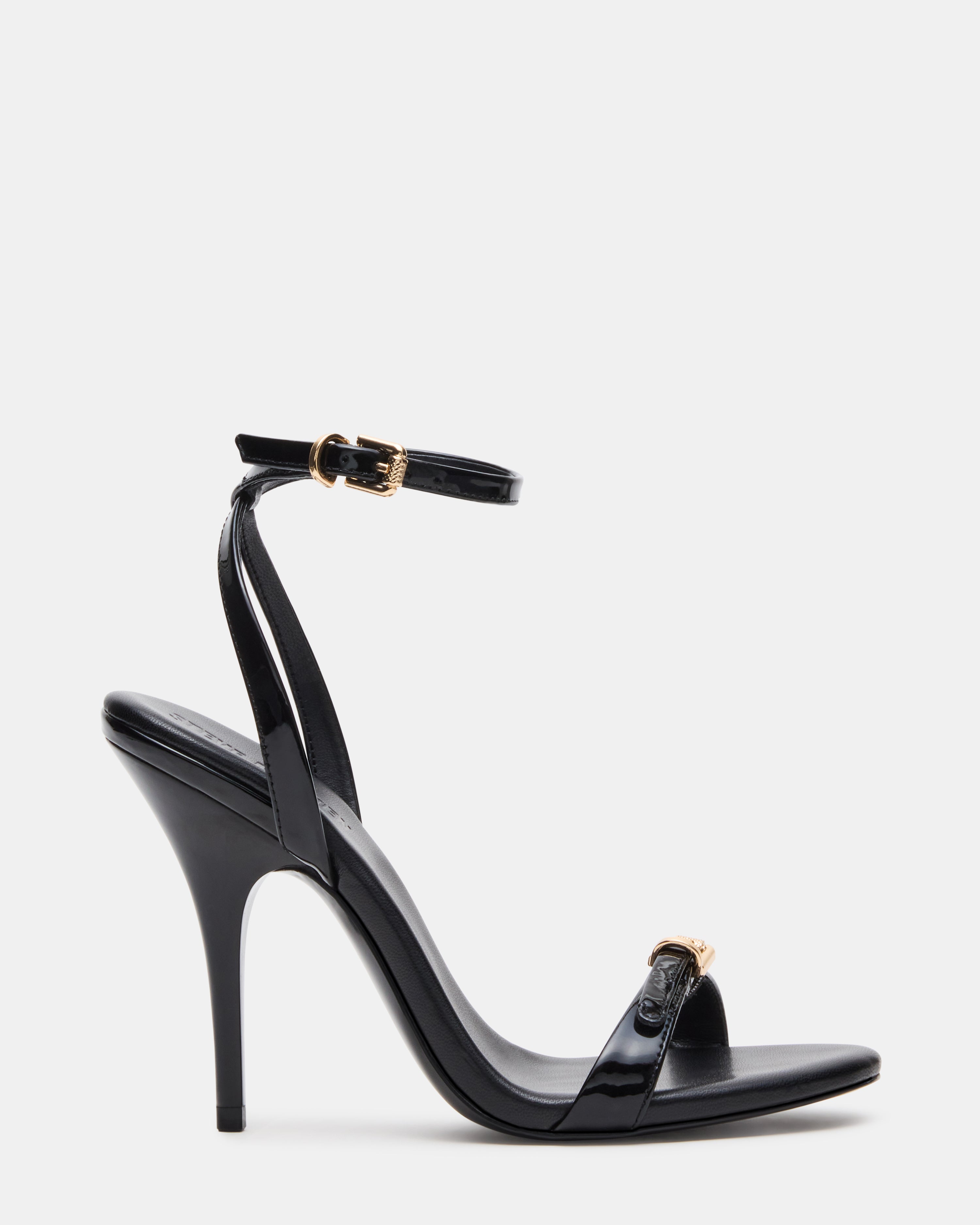 Close-up of FOXX black stiletto heels with buckle detailing.