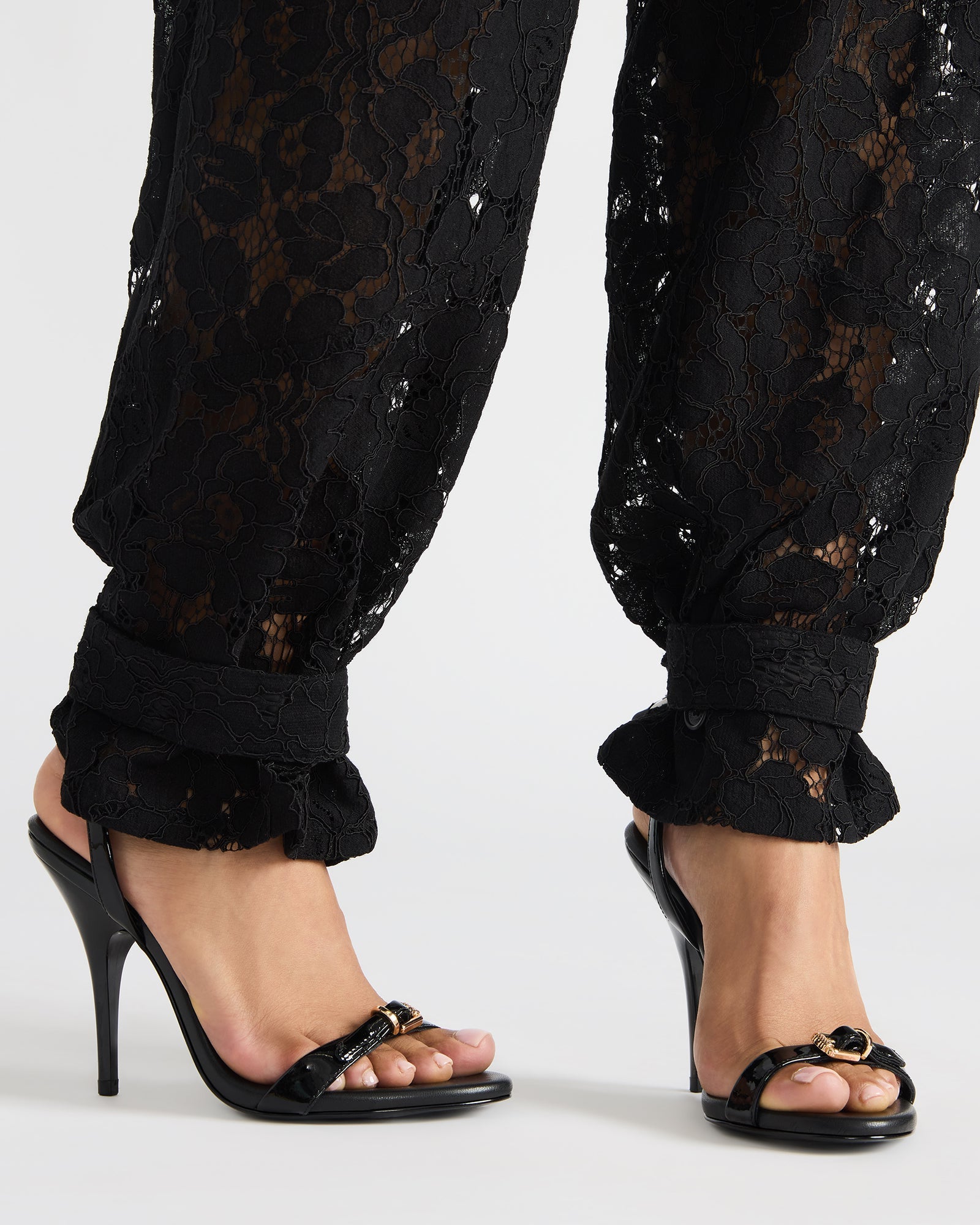 Side view of womens black patent stiletto heels showcasing the elegant design.