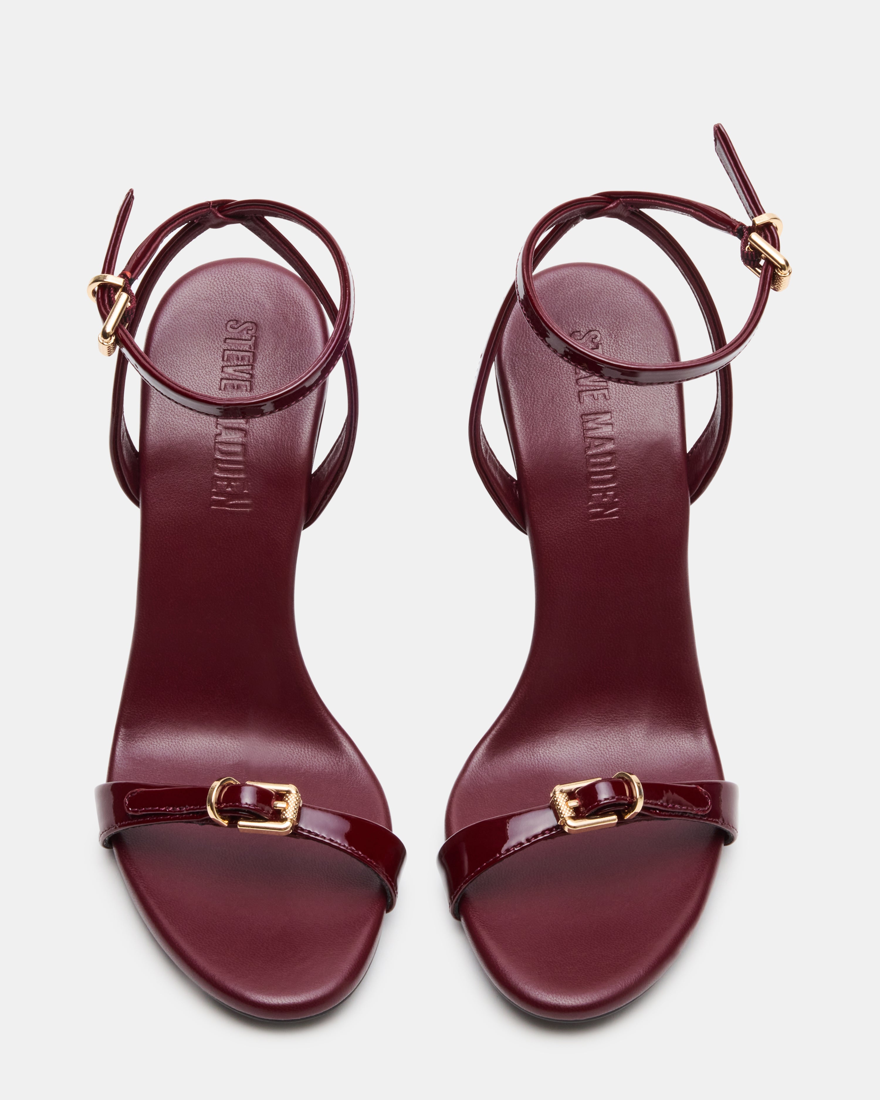Side view of burgundy slingback stiletto heels showcasing the buckle detail.