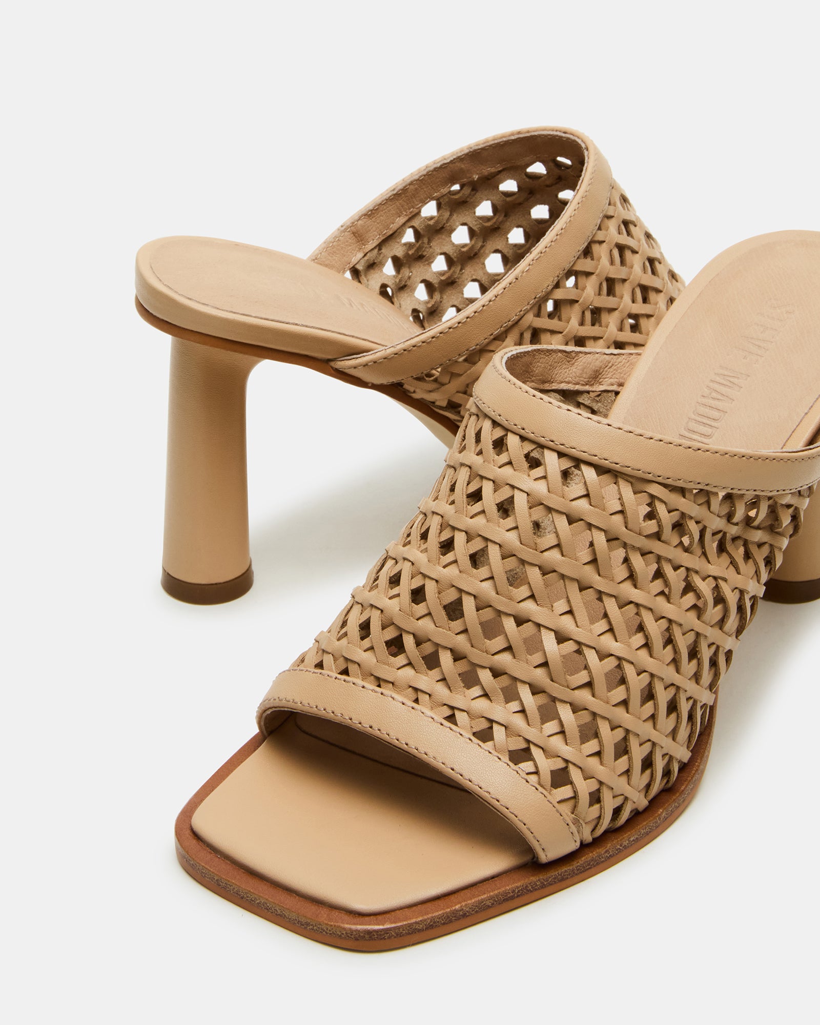 Lifestyle shot featuring womens high heel mule shoes paired with cropped denim