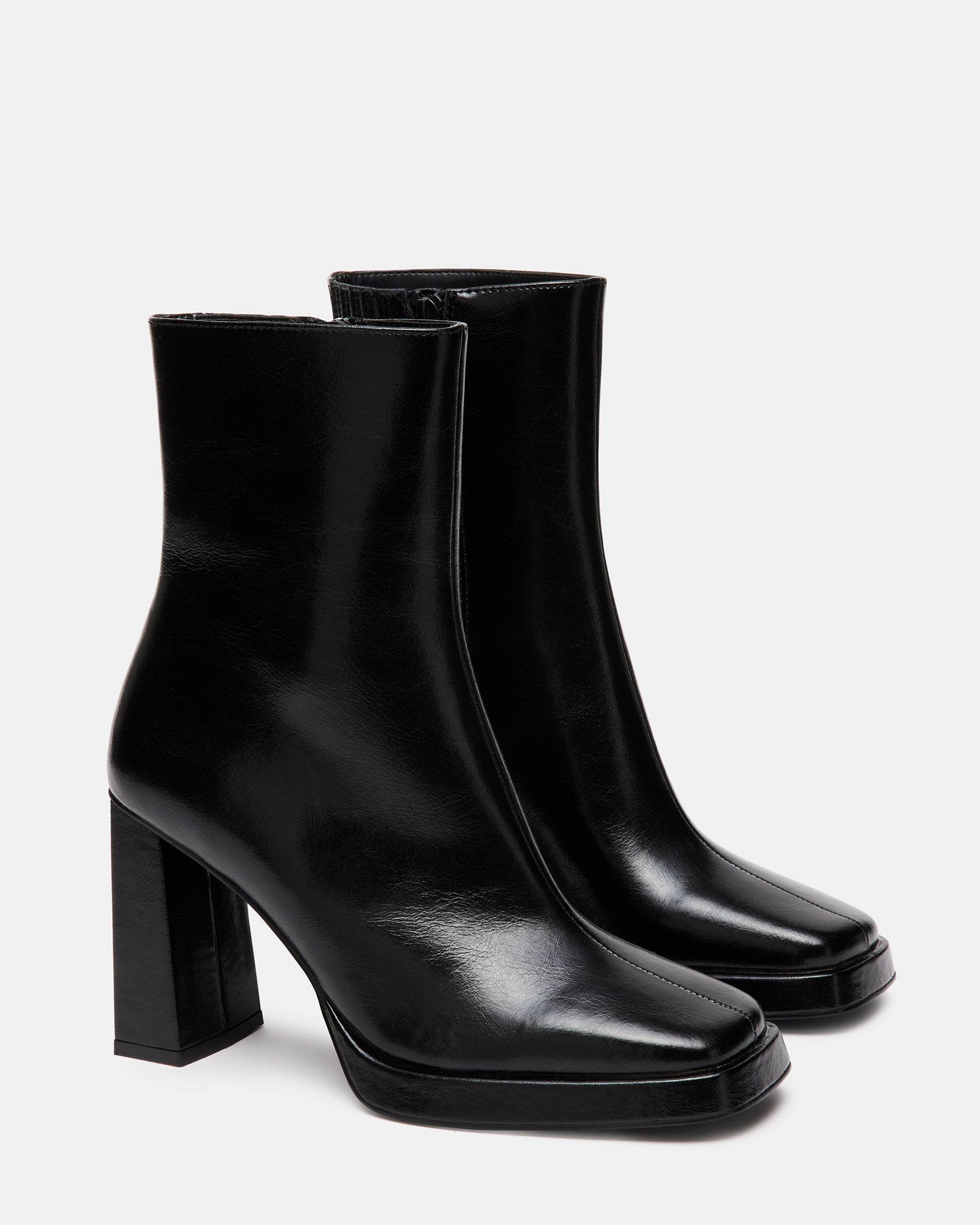 Styled shot of FREYA black leather booties worn with casual and chic outfits
