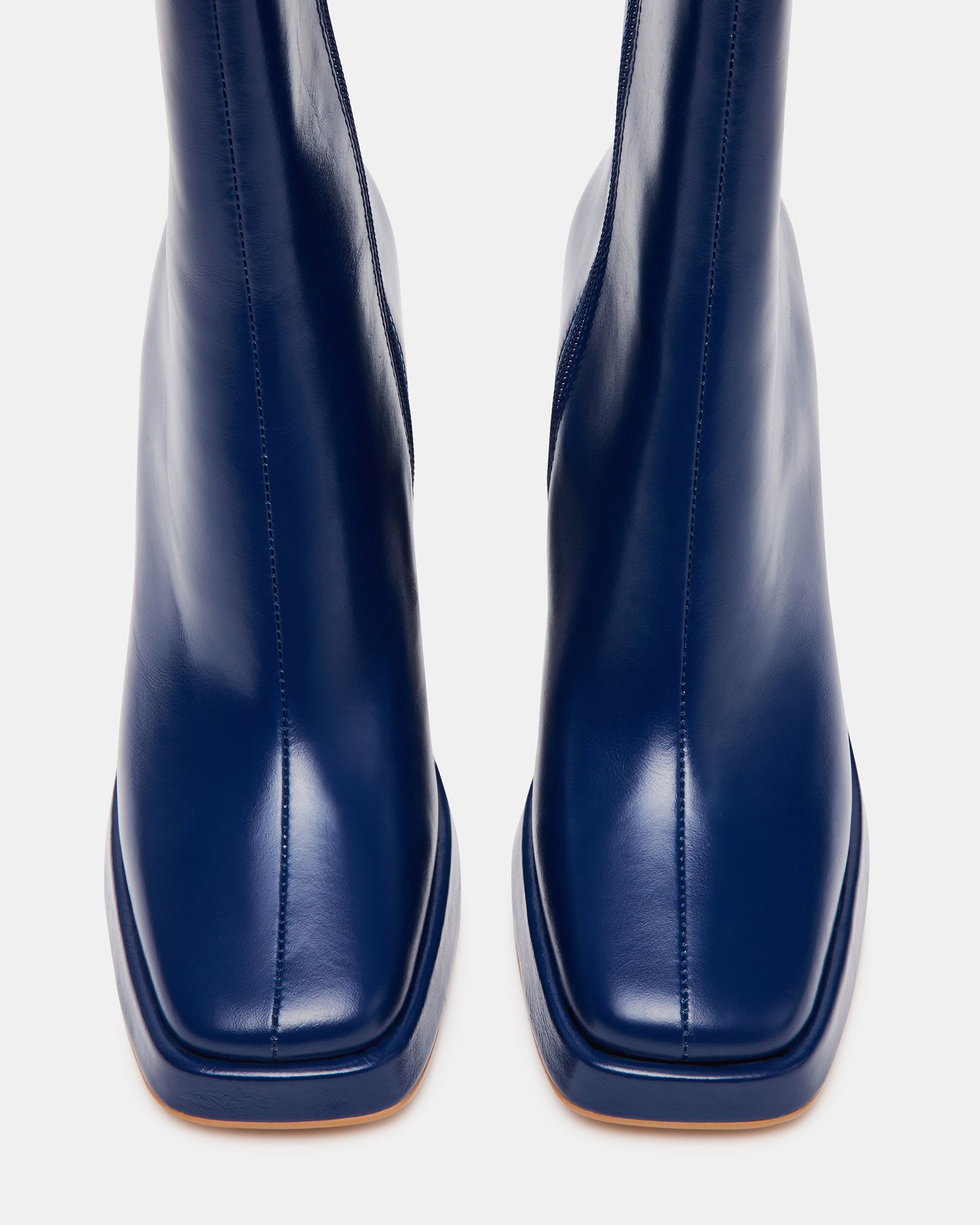 Close-up of the square toe and block heel of the navy booties.