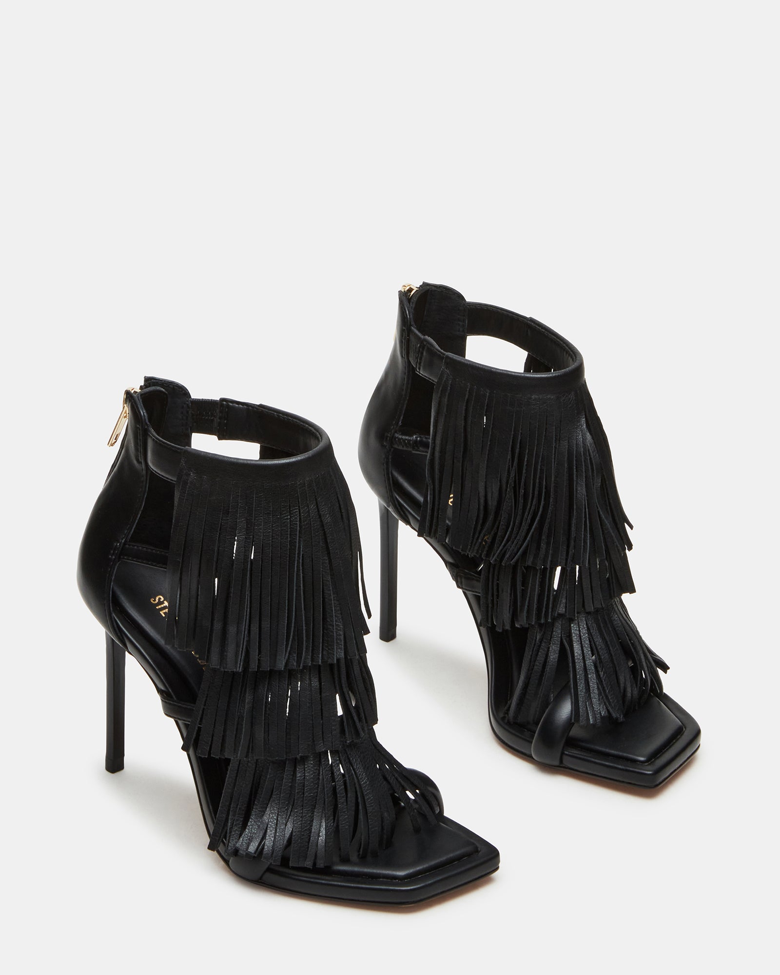 Close-up of square toe and fringe detail on fashion heels